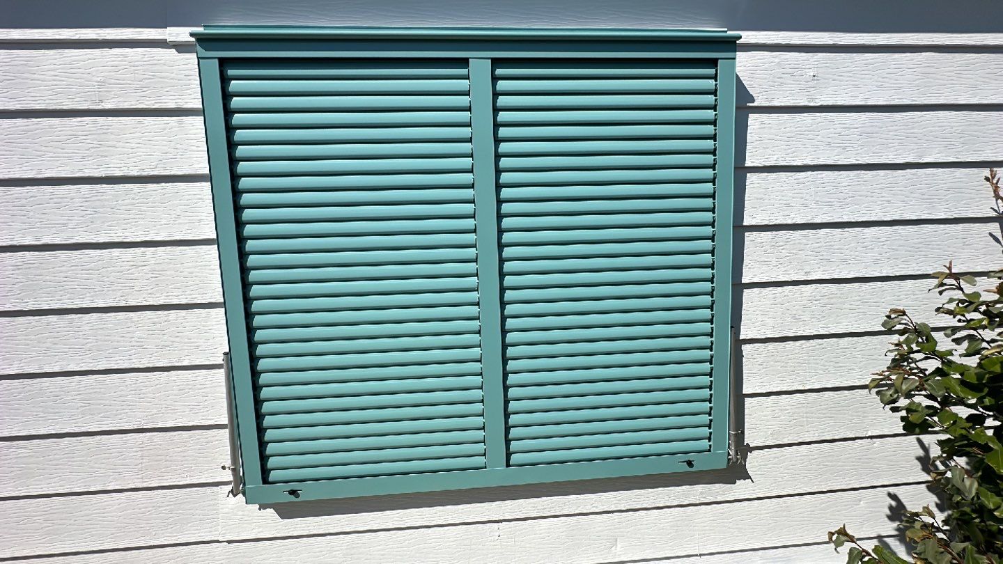 Hurricane Rated Bahama Shutters in Pastel Turquoise by Smart Guard Shutters