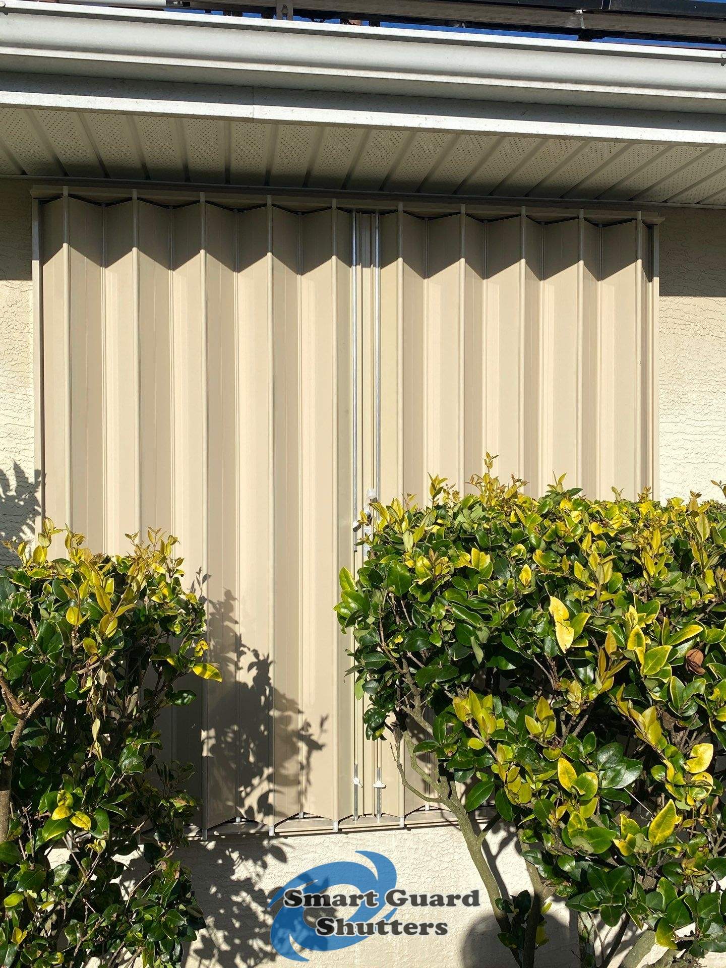 Accordion Shutters in Beige by Smart Guard Shutters