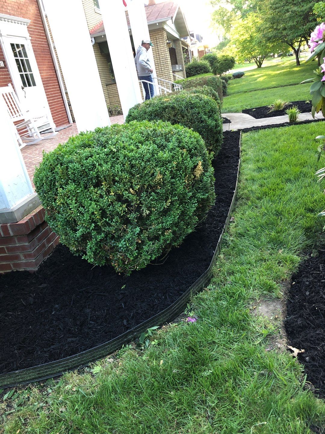 Liriope grasses, mulch and stone pavers by GrassBusters, Inc.