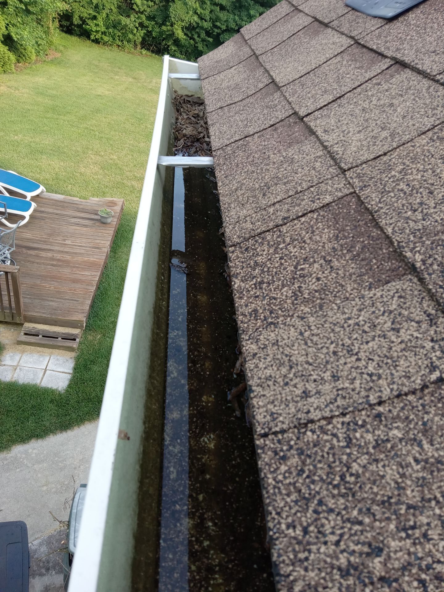 gutter cleaning by removing debris and flushing out downspouts