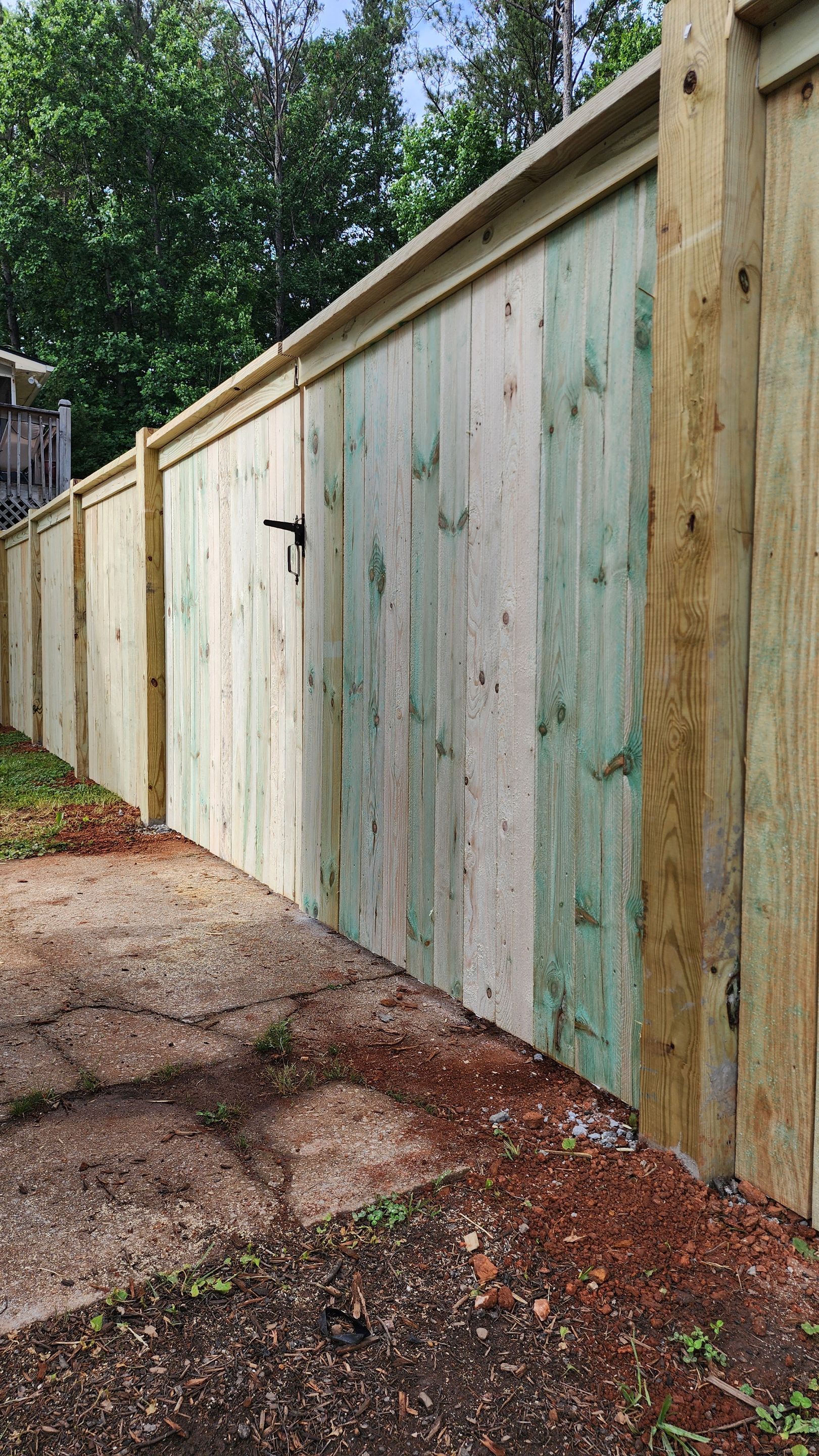 Fence Installation of Capped Wood Privacy Fence by Titans of Timber Fence & Stain