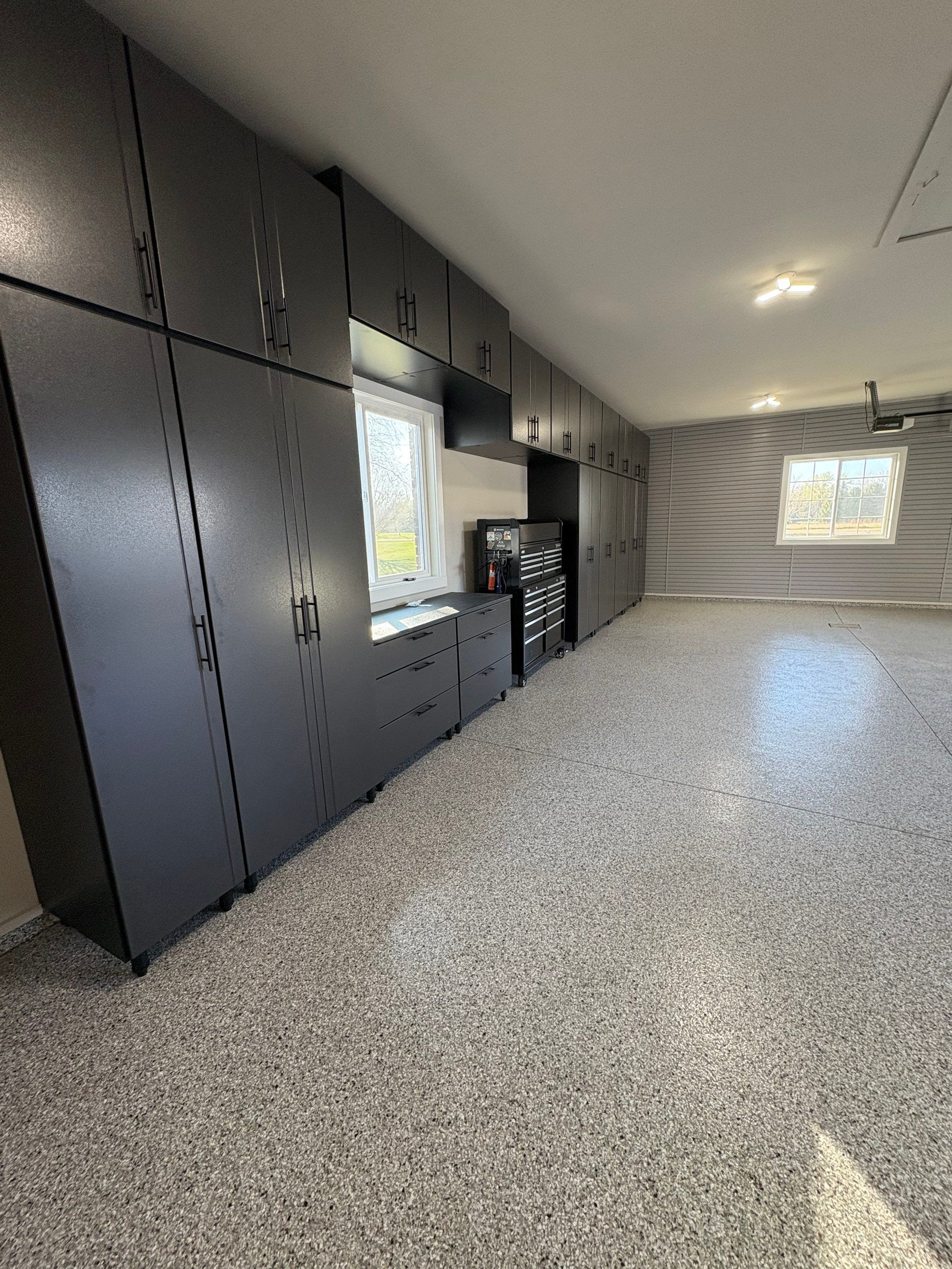 Yankton Garage Transformation with Dark Storage Cabinetry and Epoxy Flooring by Select Painting, Coatings & Garage Cabinets
