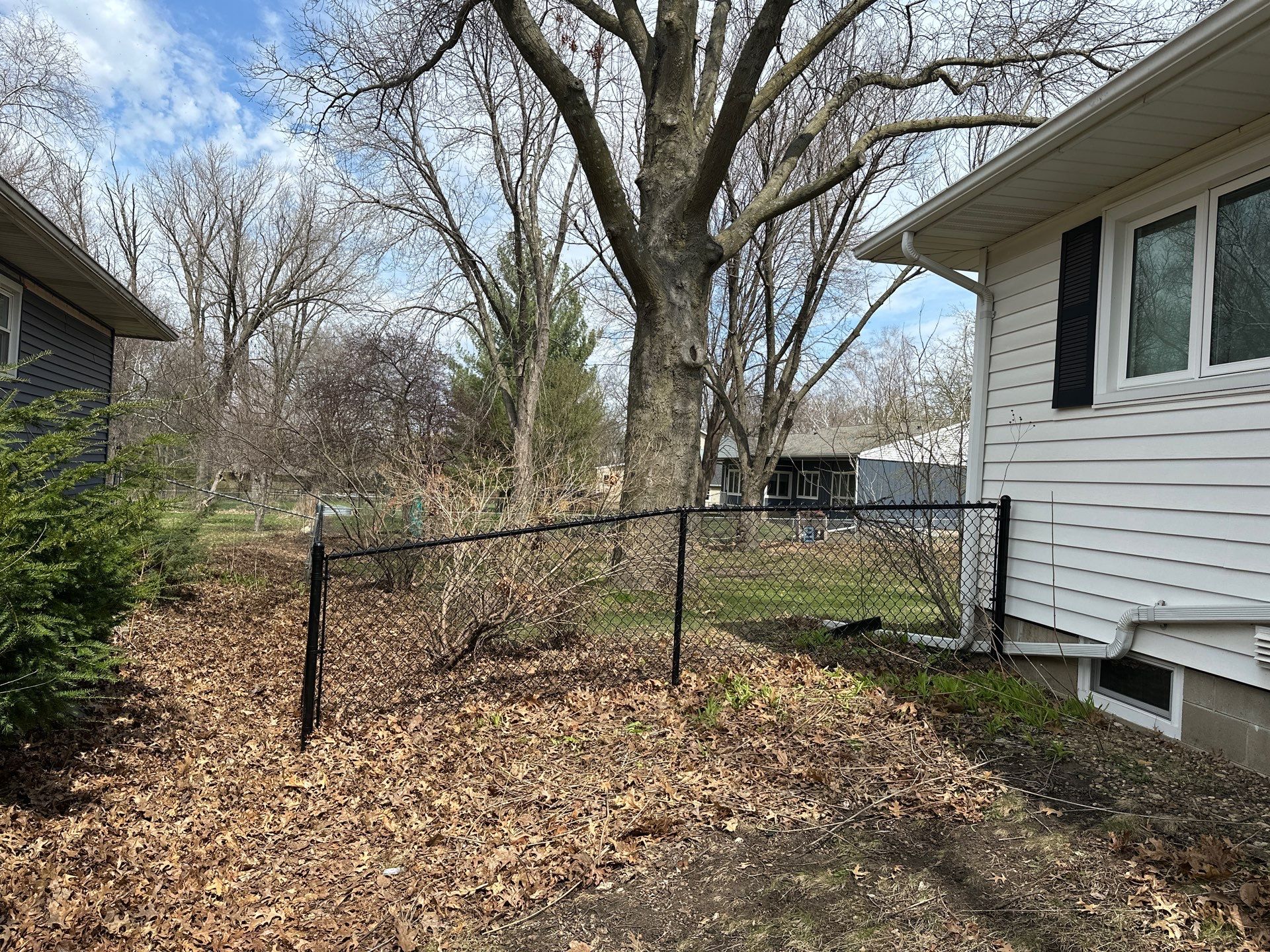 Black Vinyl-Coated Chain Link Fence Installation in Cedar Falls by Perfect Picket Fence and Stain
