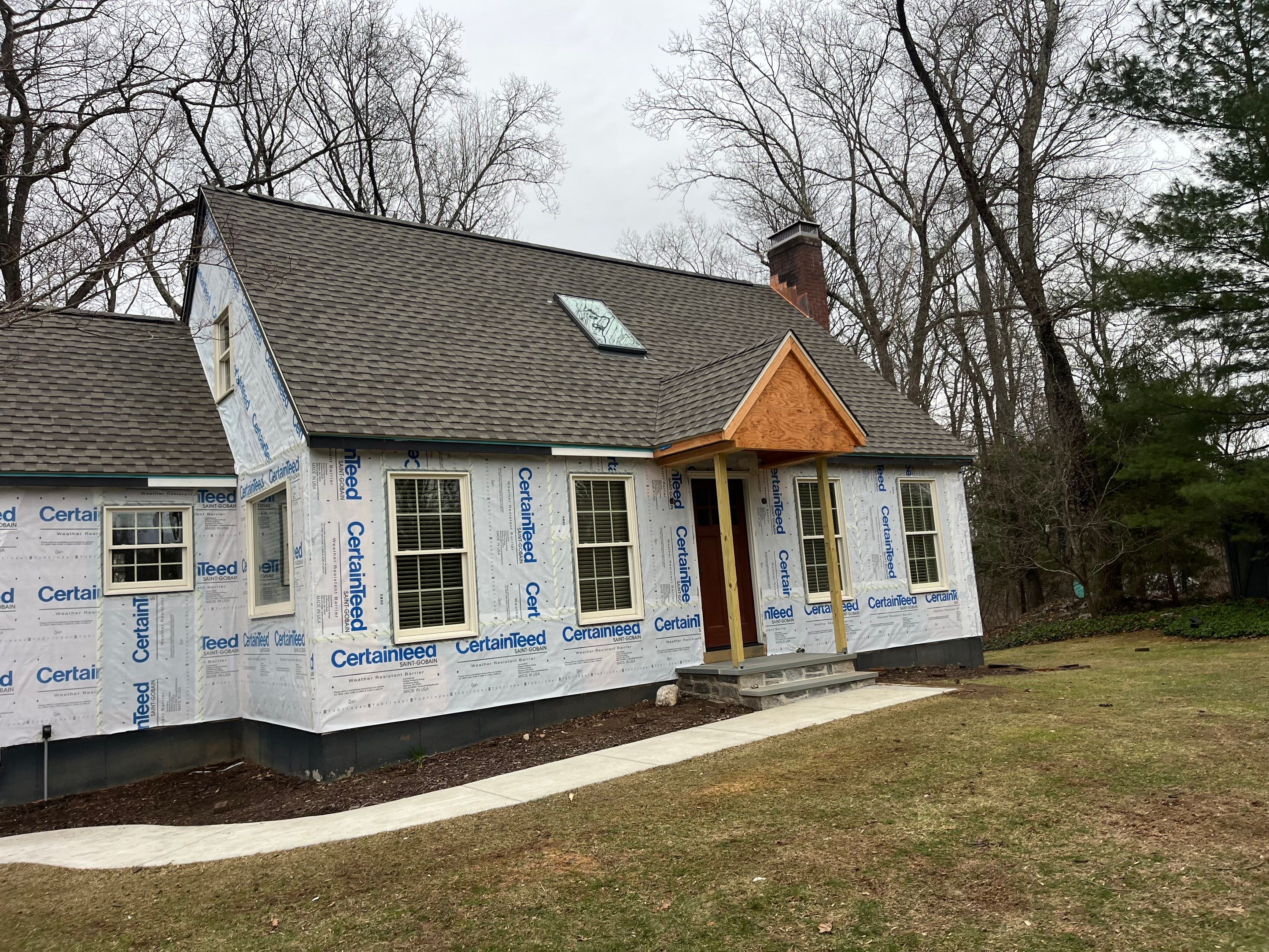 Asphalt shingles meet sleek siding in Guilford. by DiGiorgi Roofing and Siding Inc