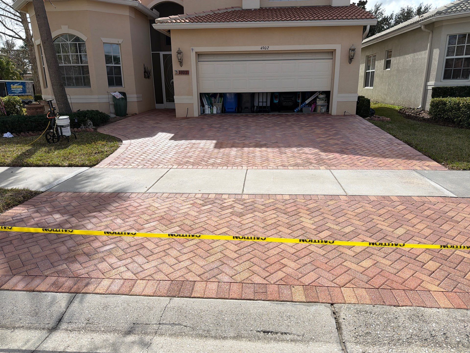 Paver Sealing for Herringbone Driveway and Screened Lanai in Valencia Lakes by Supreme Paver Experts