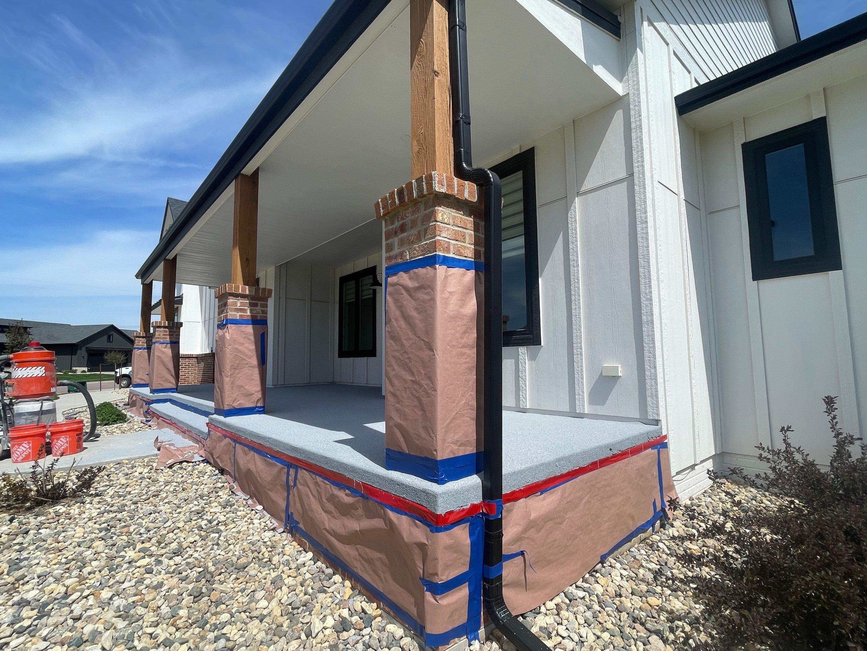 Grey Speckled Concrete Porch Coating for Sioux Falls Home by Select Painting, Coatings & Garage Cabinets
