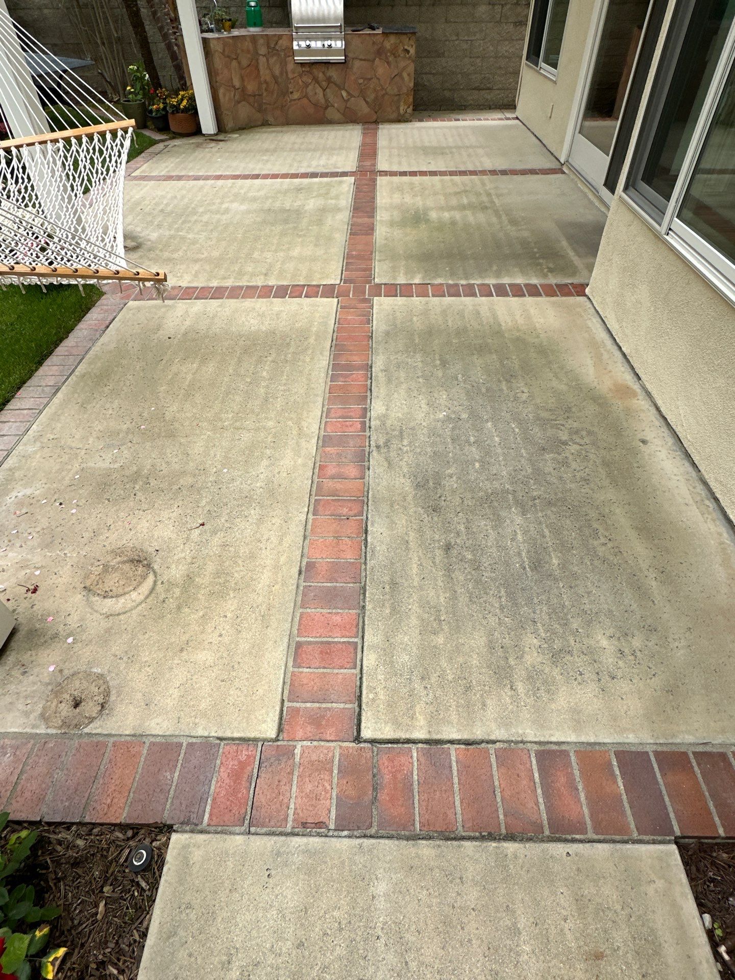 Surface cleaning pressure washing in Orange County on patio, walkways, and driveway by Property Cleaning Experts, LLC