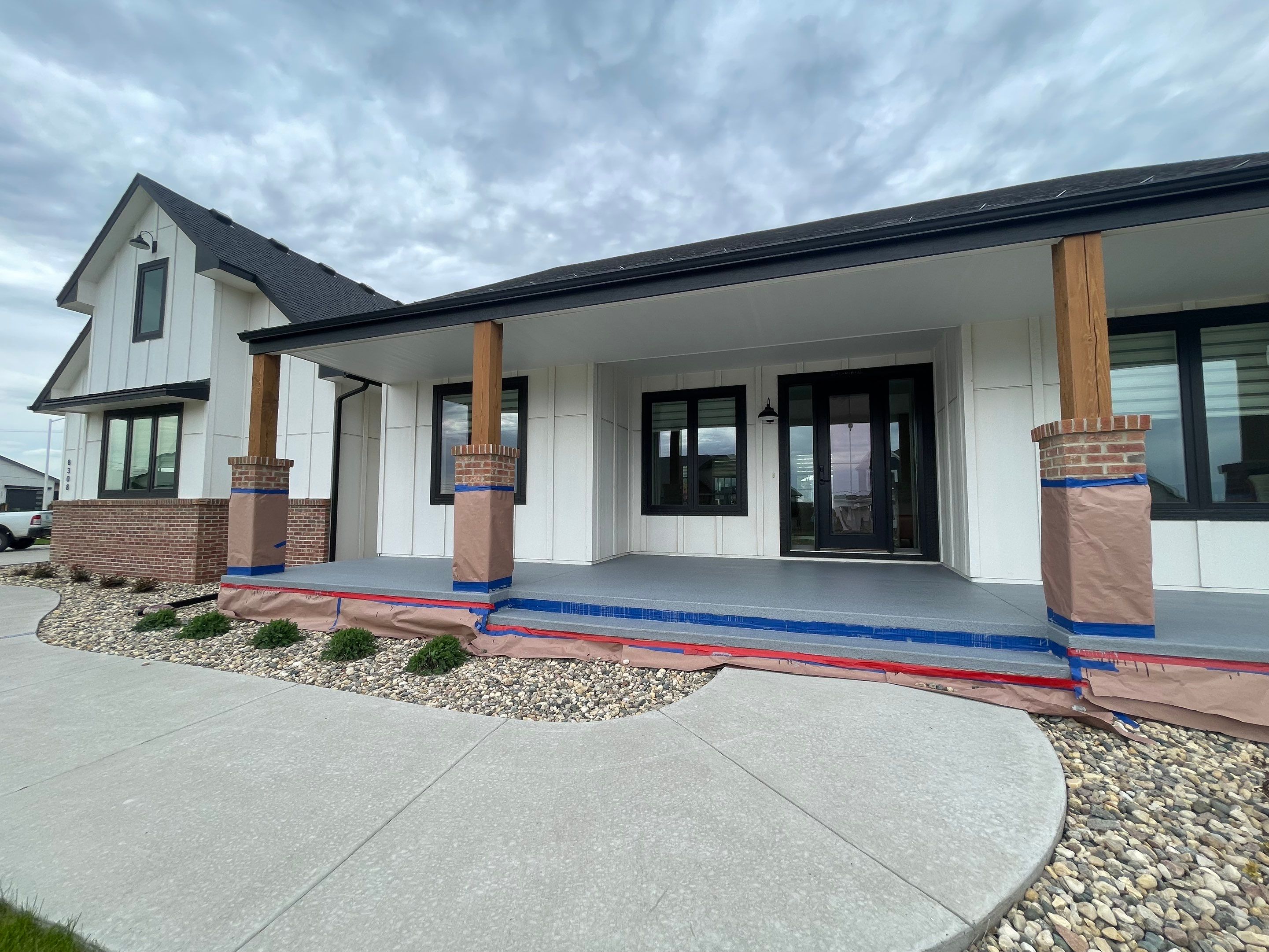 Grey Speckled Concrete Porch Coating for Sioux Falls Home by Select Painting, Coatings & Garage Cabinets
