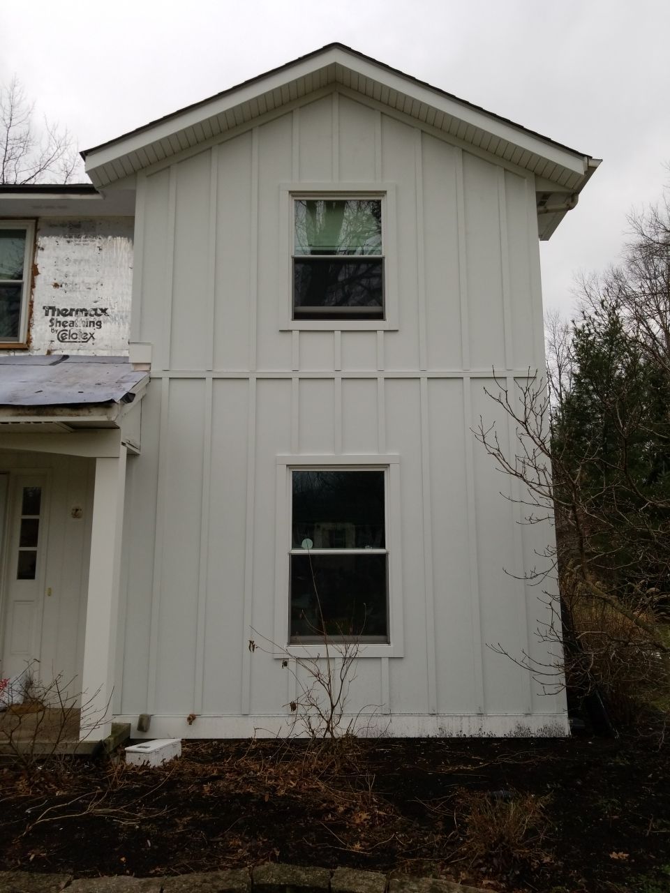 James Hardie Siding  using James Hardie Board and Batten, White by Absolute Roofing and Construction