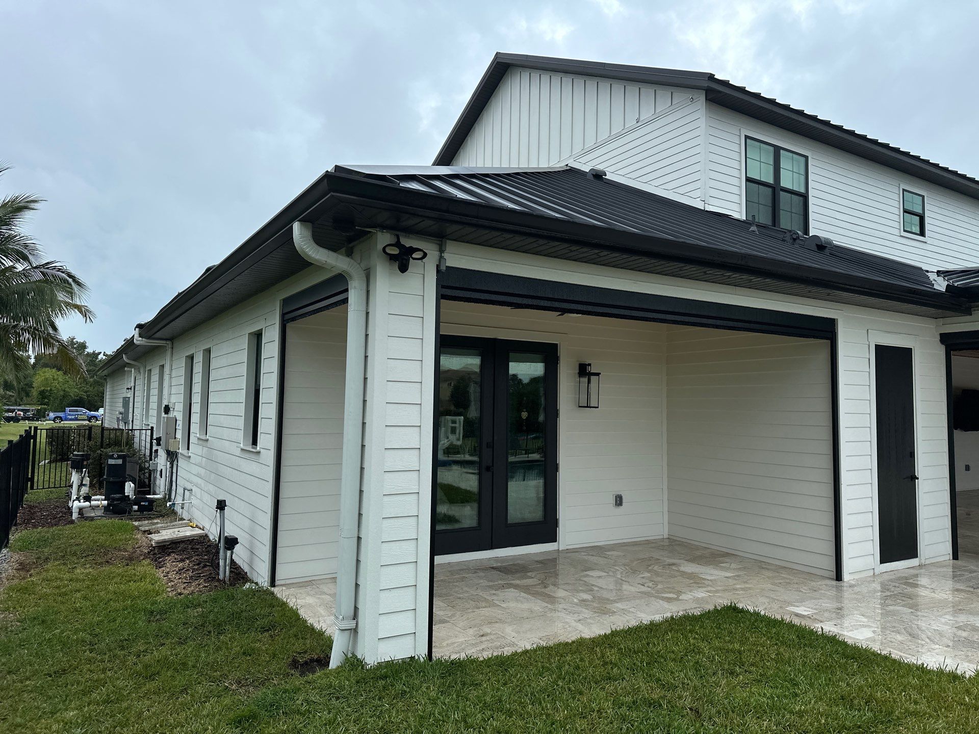 Complete Two-Story House Wash and Driveway Cleaning in Winding River Community, Bradenton, FL by Sunshine AquaWash