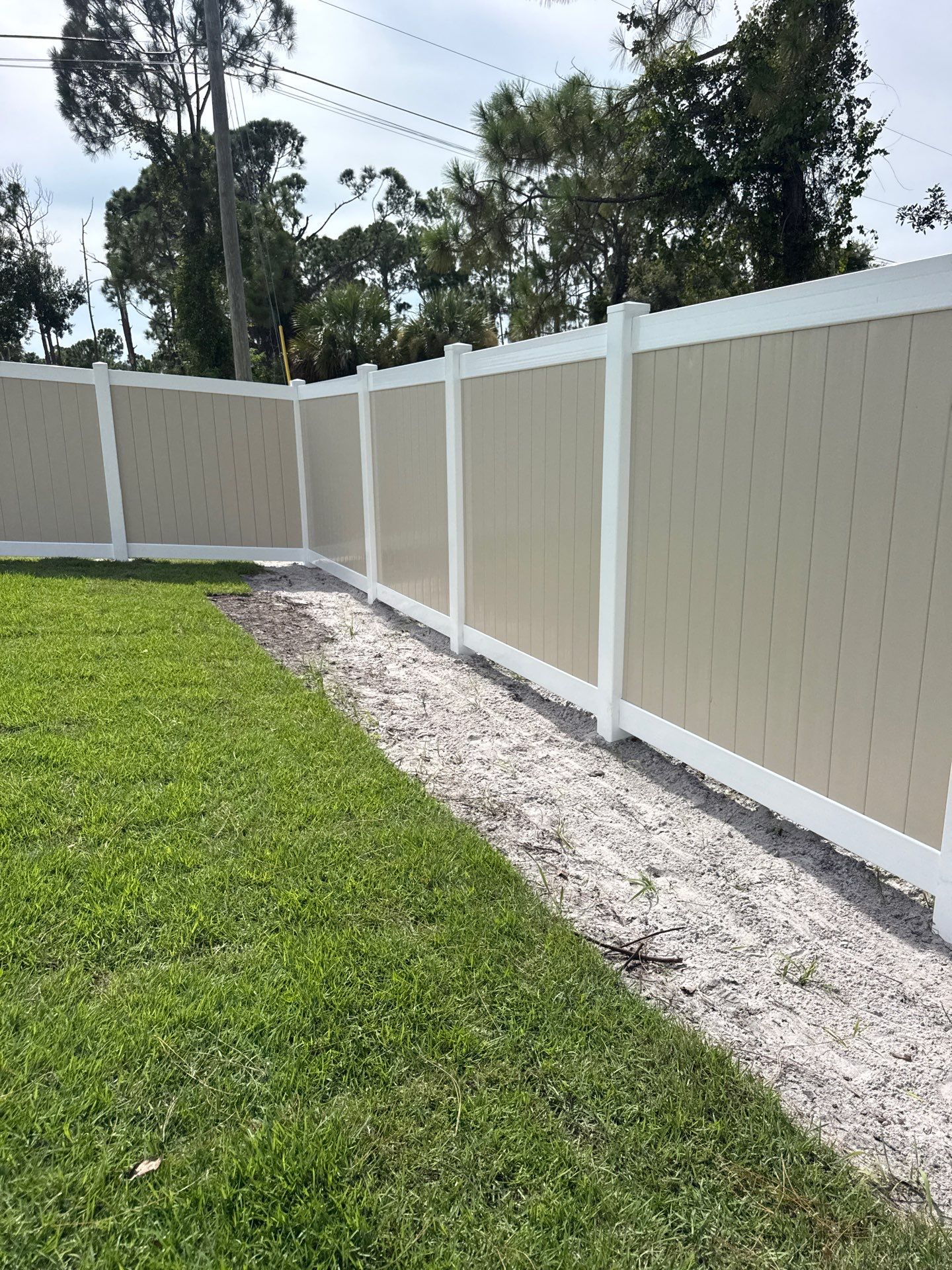 Custom Two-Tone Vinyl Privacy Fence Installation in North Port by True Fence LLC