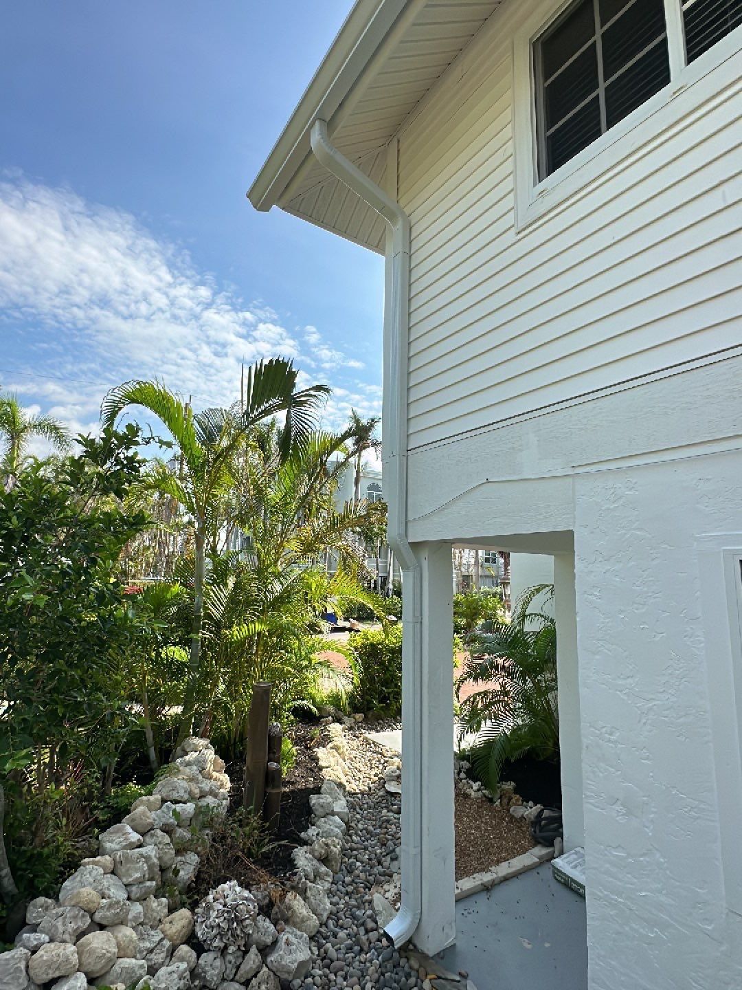 White K-Style Gutters Installed with White Downspouts in Sanibel FL by Gutter Professors