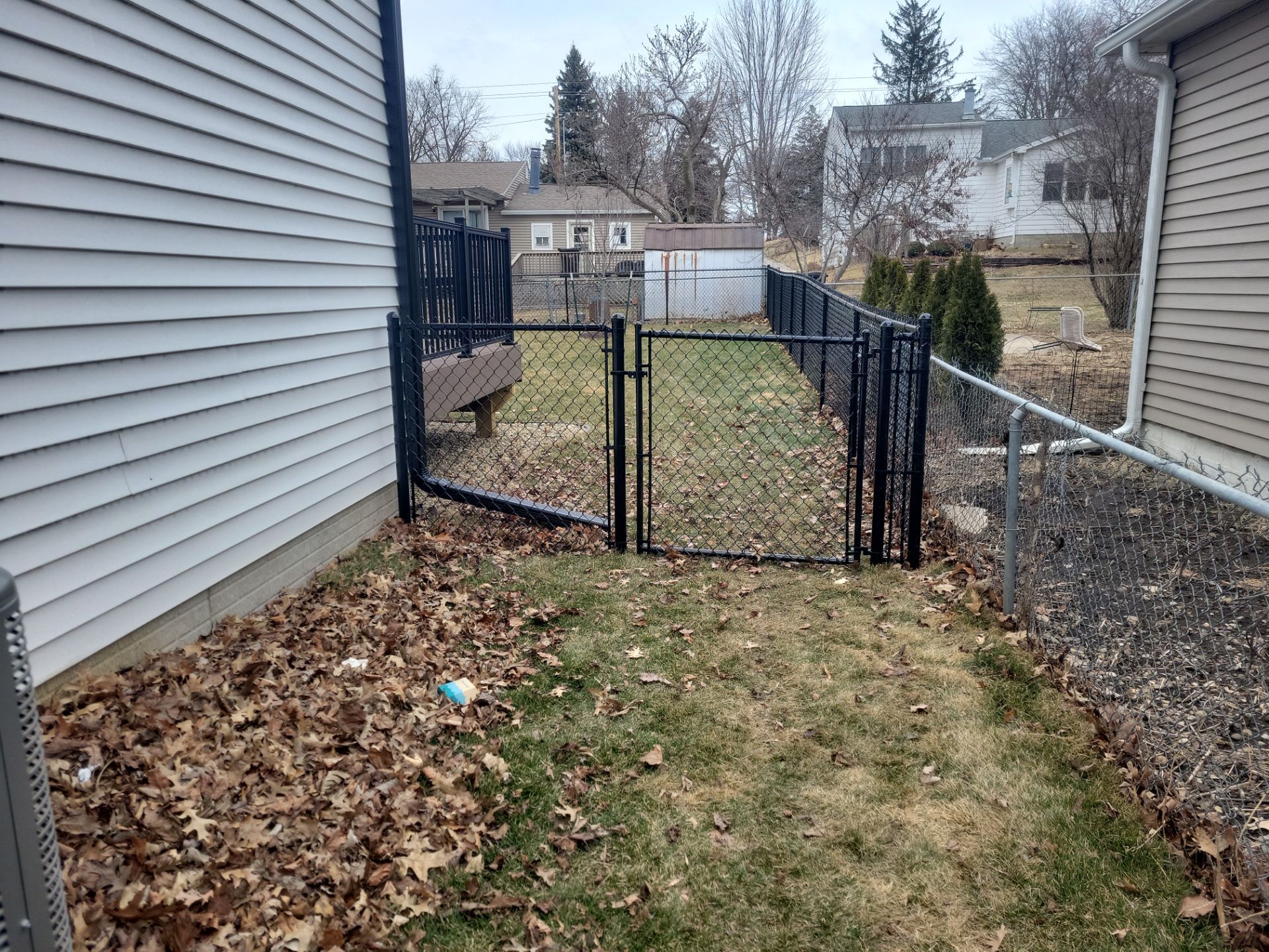 Black Chain Link Backyard Fence and Gate Installation in Cedar Falls by Perfect Picket Fence and Stain
