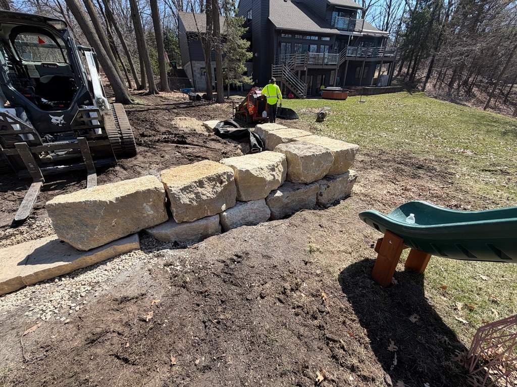 Limestone Boulder Wall  by Sota landscaping