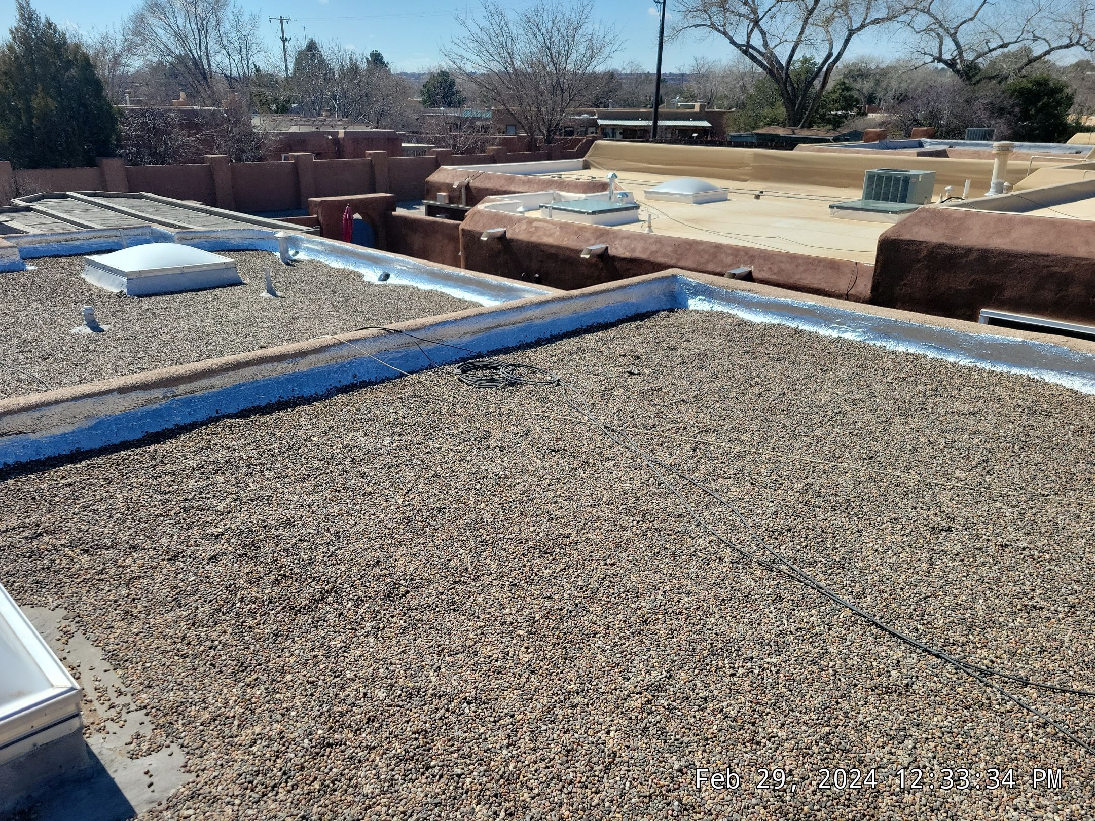 Roof Maintenance and Low-E Tempered Glass Skylight Replacement on Gravel Roof in Northwest Albuquerque by Doyle Roof Masters Inc