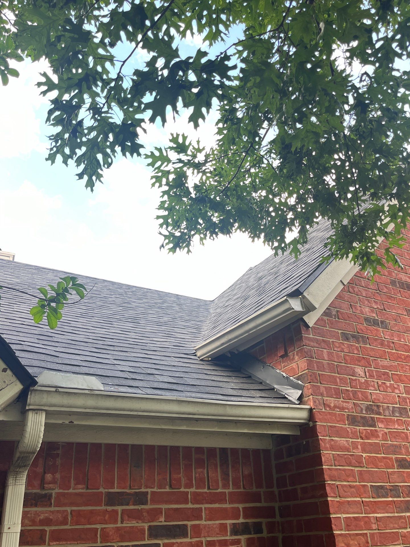Red brick with Malarkey Midnight Black  by Tejas Roofworks + Restoration