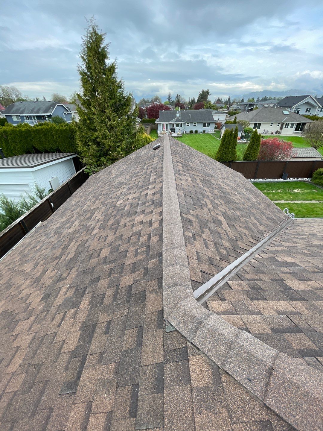 Residential patio roof extension with IKO Dual Brown shingles by Top Notch Roofing Inc