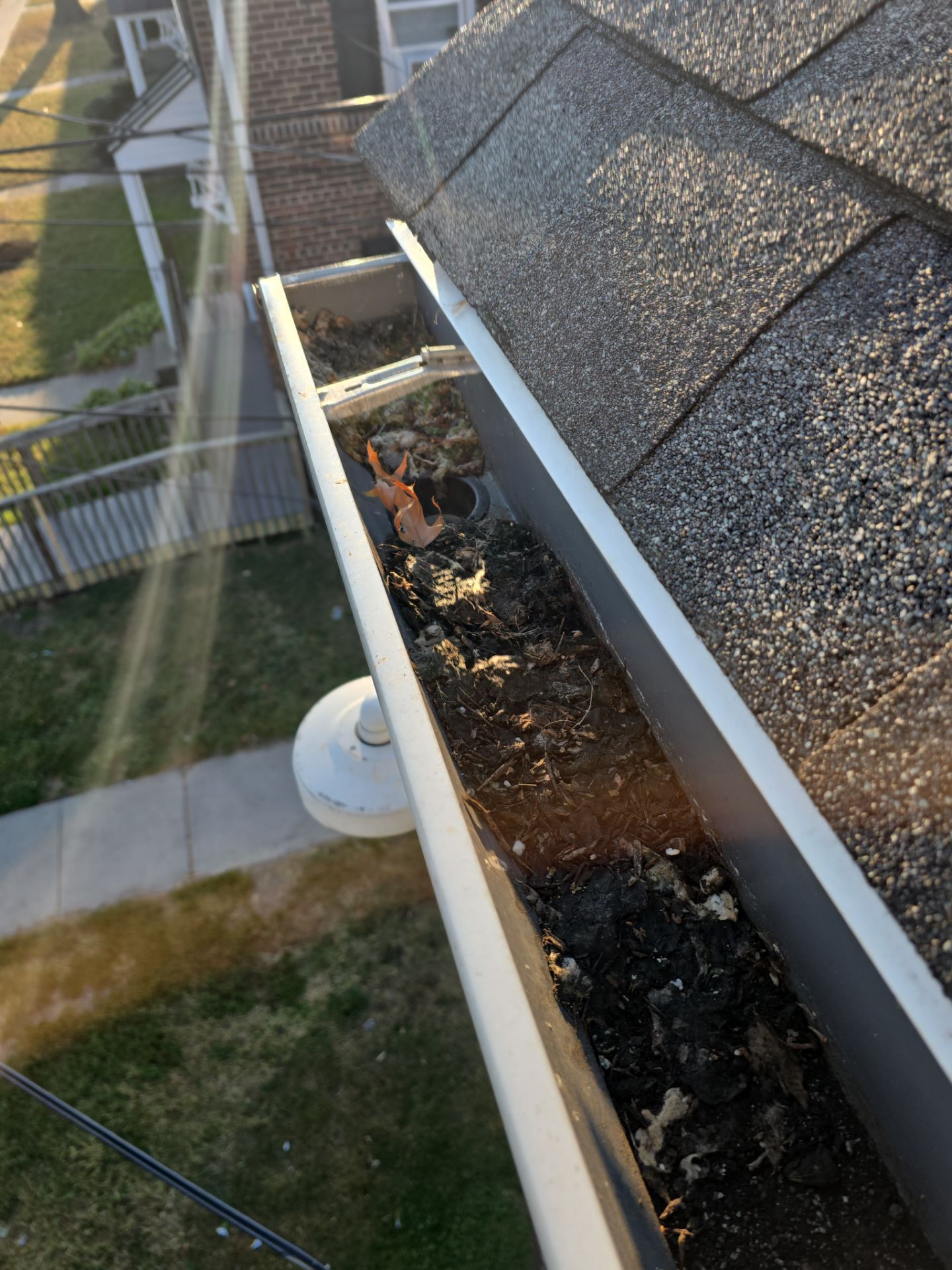 Commercial gutter cleaning Cherry Hill & Camden, NJ before photo with filled gutters