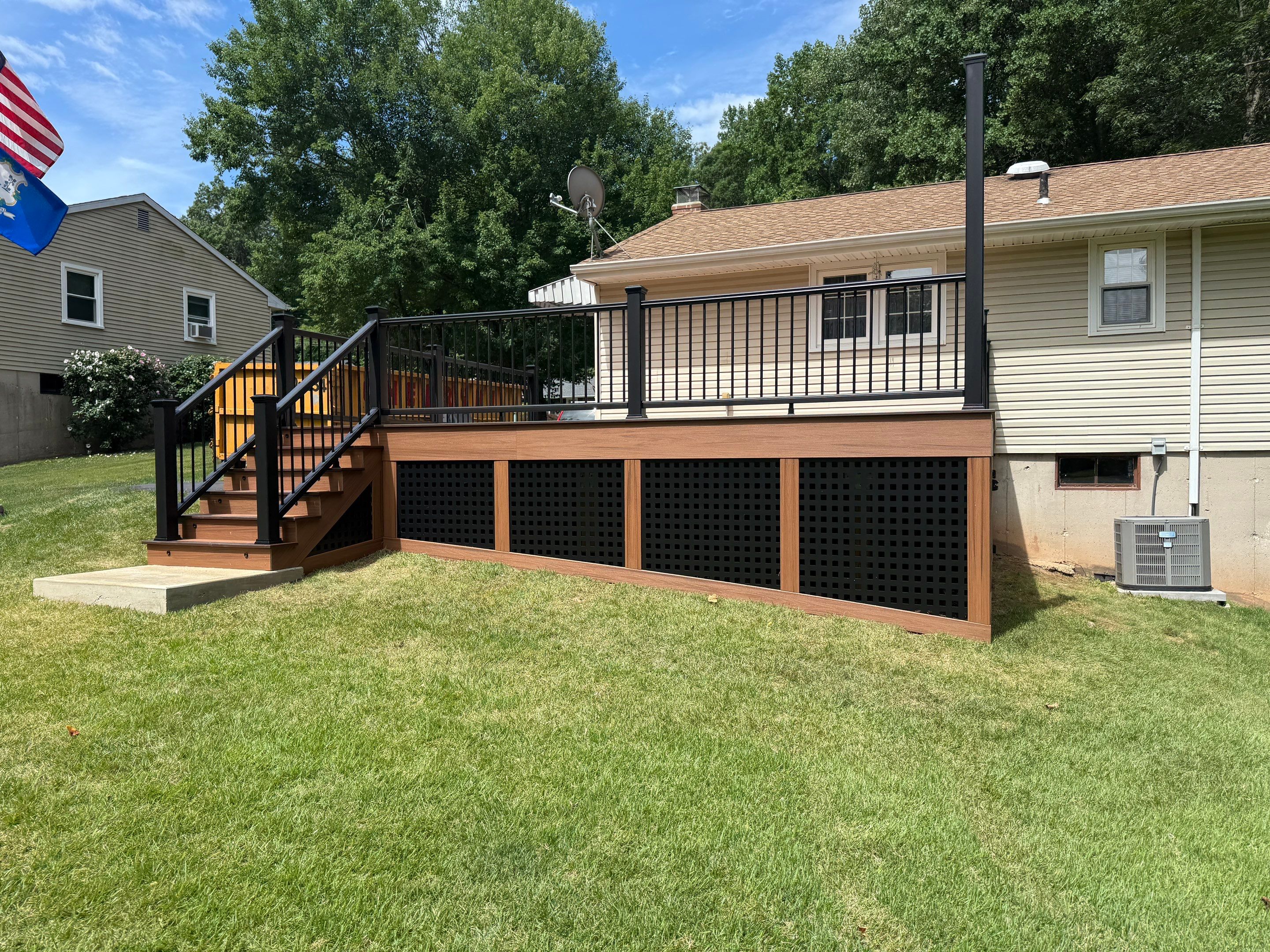 Replacement Deck, Trex Tropical Tiki torch , Matching Fascia. Black Transcend railing and Lattice. by DiGiorgi Roofing and Siding Inc