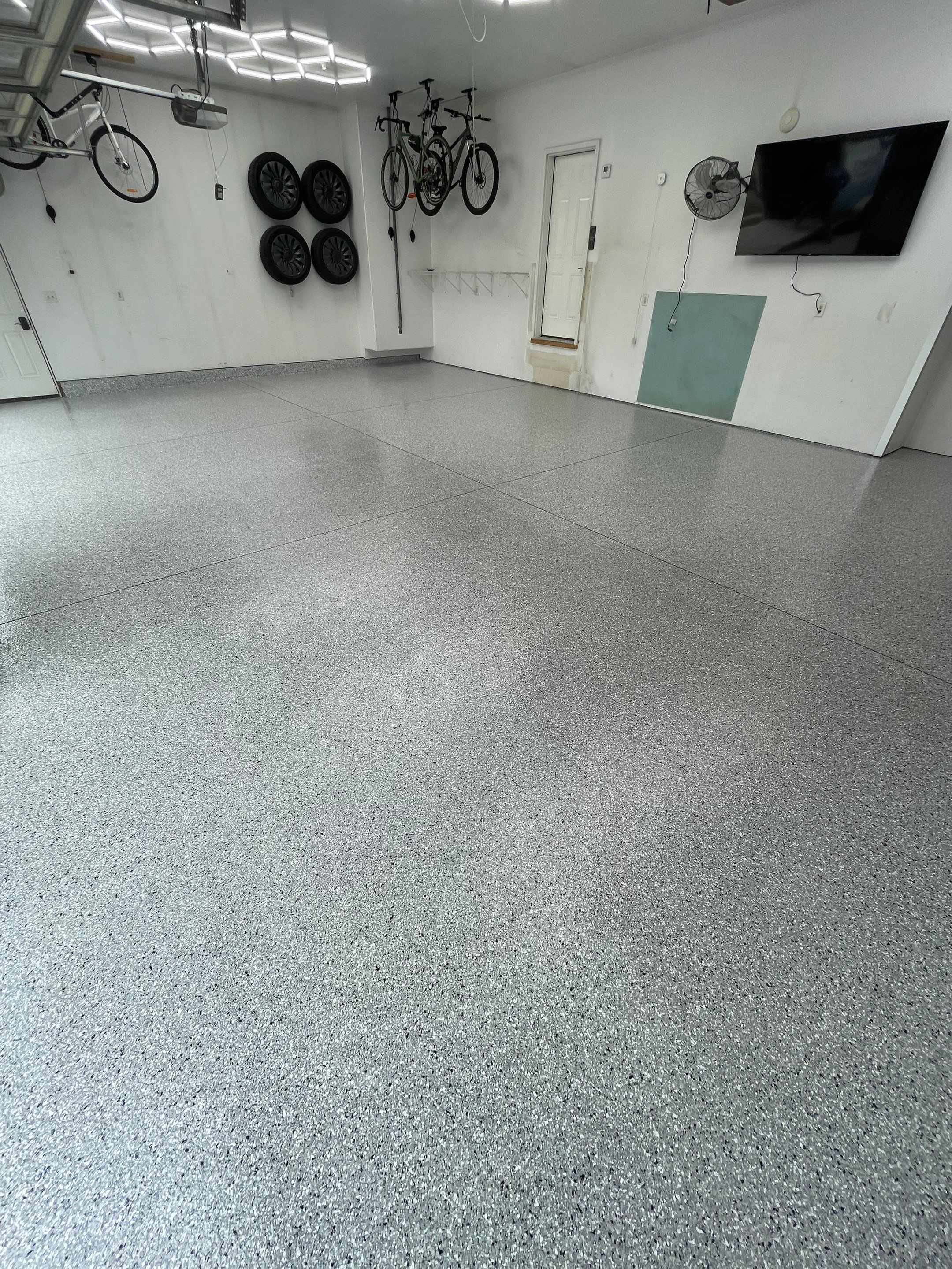 Feather Gray Epoxy Floor Coating Installation in Sioux Falls by Select Painting, Coatings & Garage Cabinets