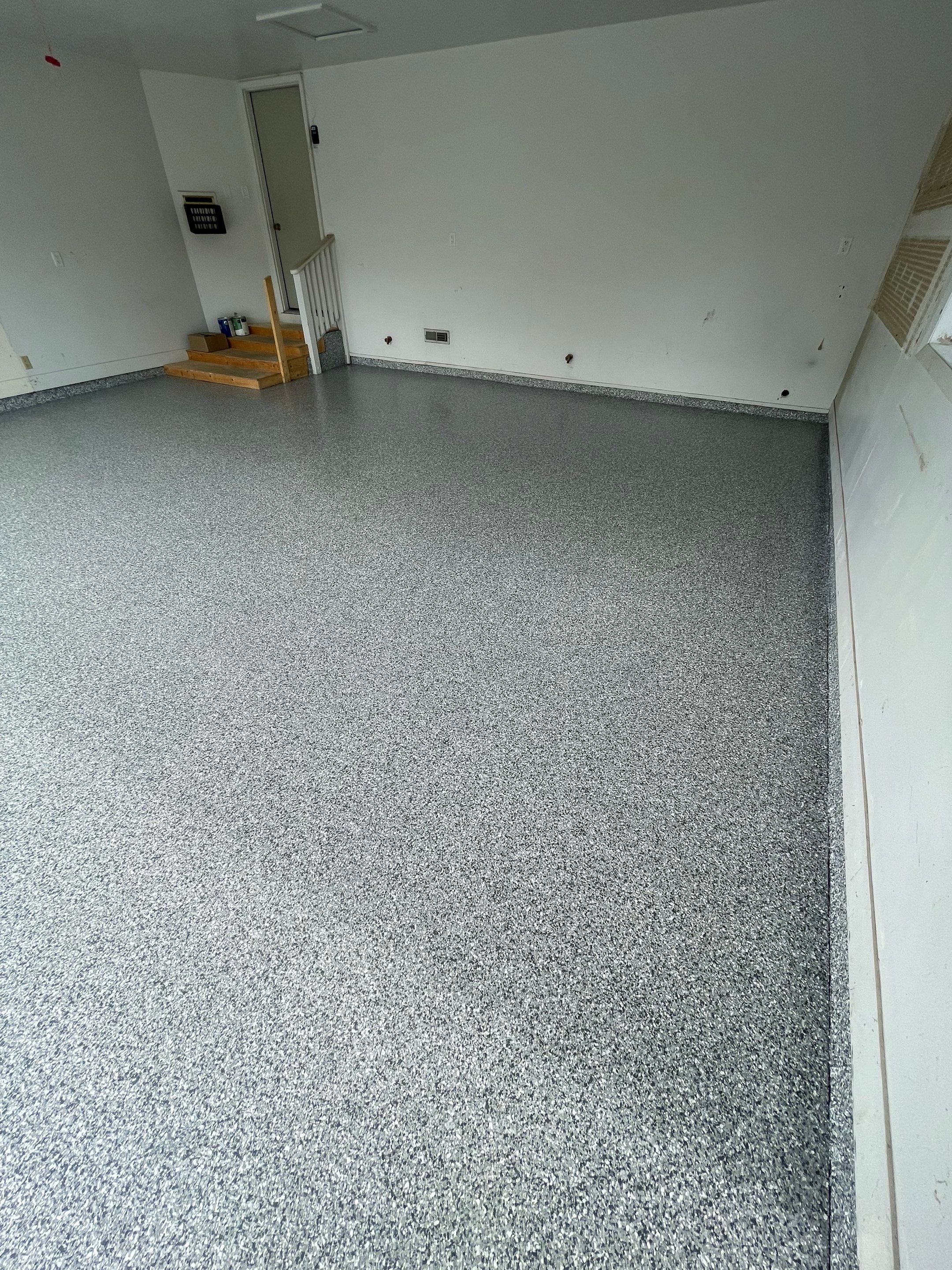 Grey Speckled Concrete Coating for Residential Garage in Yankton by Select Painting, Coatings & Garage Cabinets
