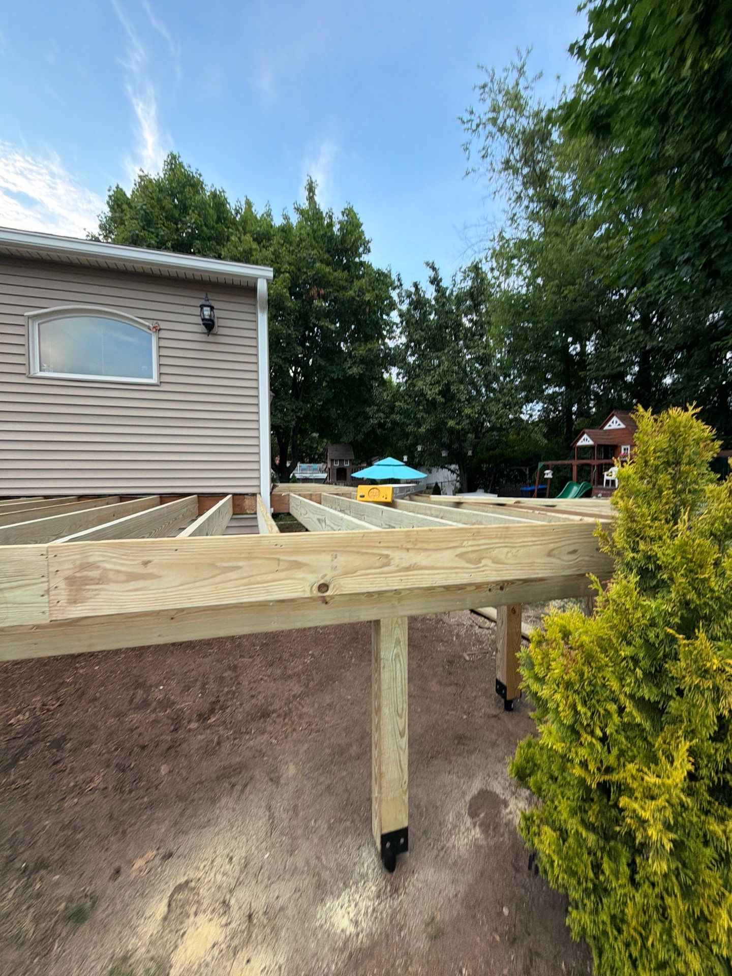 Deck Replacement using Trex Tropical Spiced Rum decking and Transcend White Railing by DiGiorgi Roofing and Siding Inc