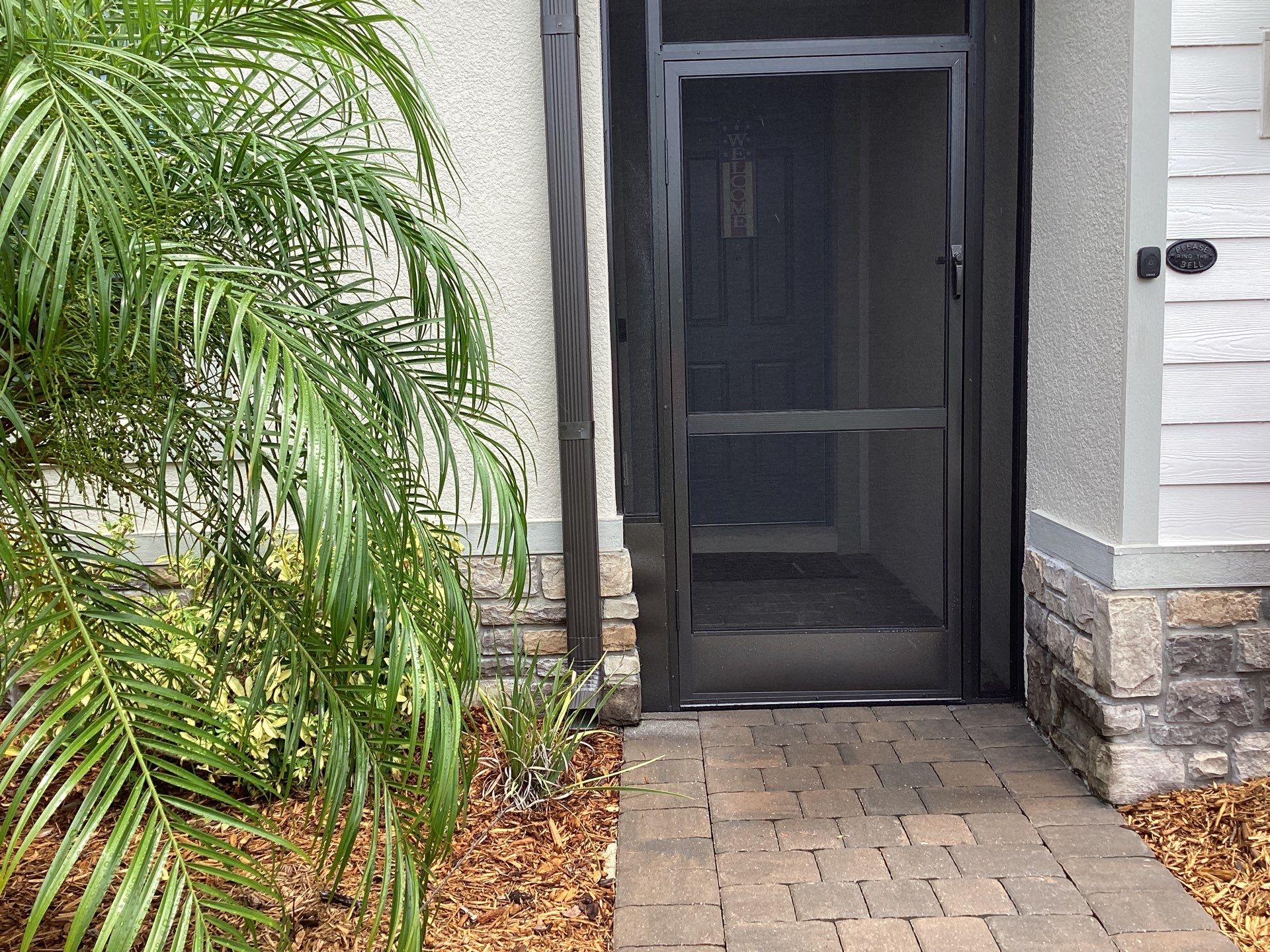 Musket brown seamless gutters with splash guards, new downspouts, and extensions in Bradenton, FL by Gutter Professors