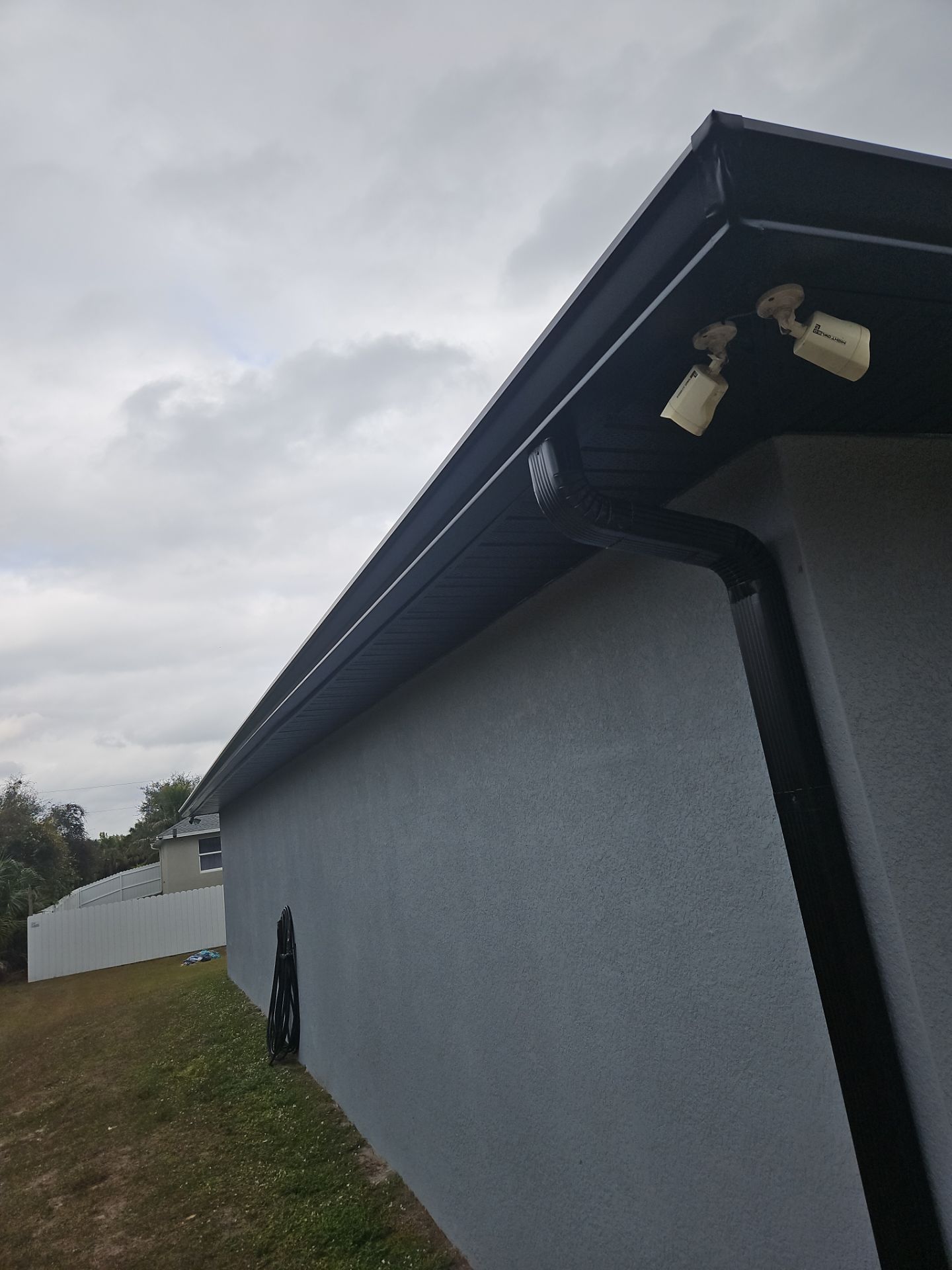 Black Seamless Gutters & Soffit/Fascia in Lehigh Acres FL by Gutter Professors