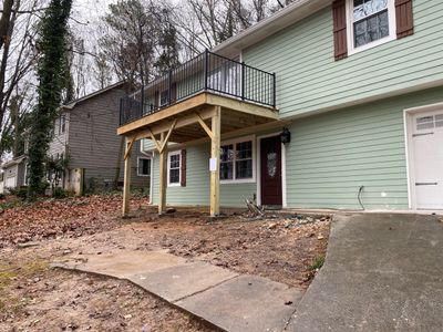 Elevated Wood Deck Construction With Black Metal Railings In Atlanta