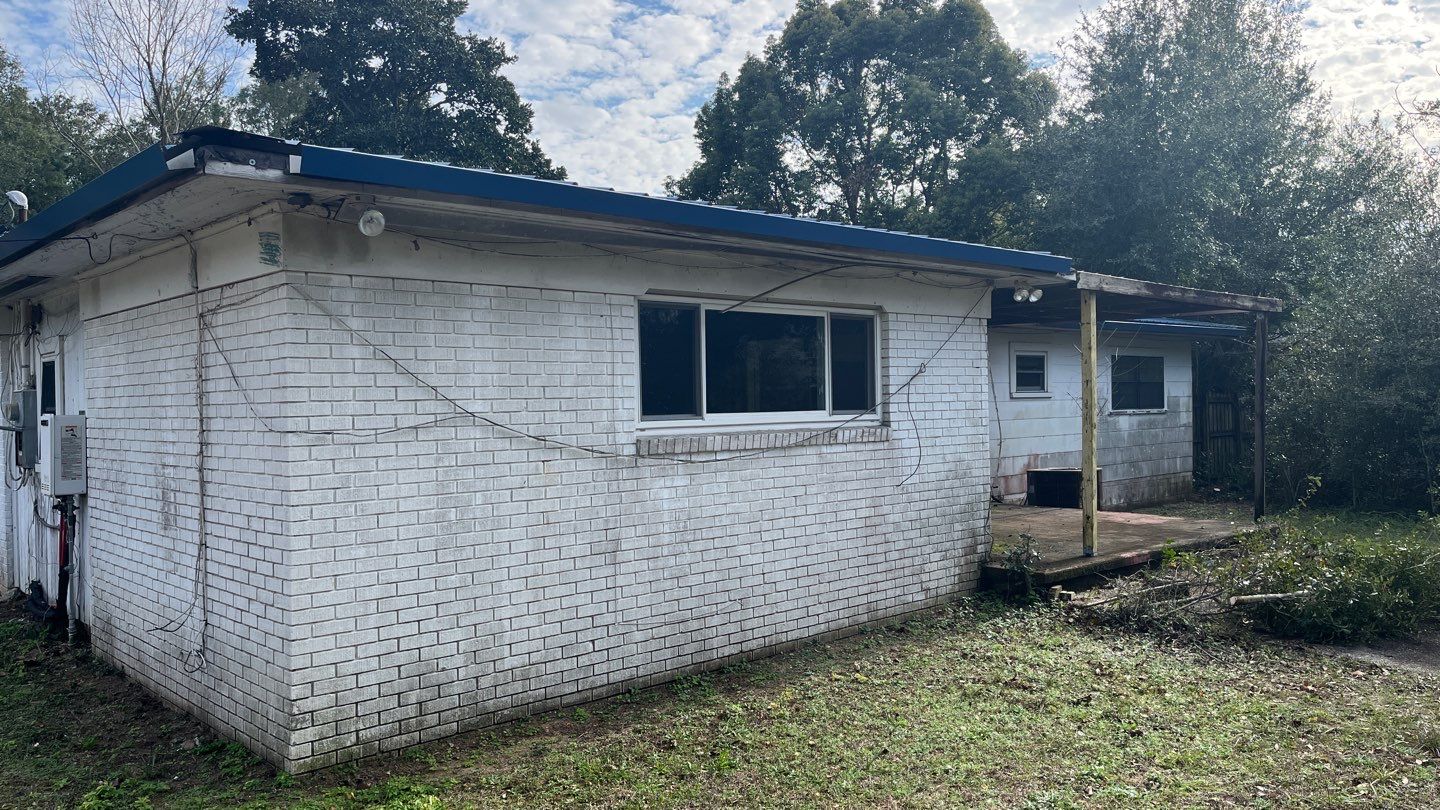White Seamless Gutters and Black Downspouts by Gutter Professors