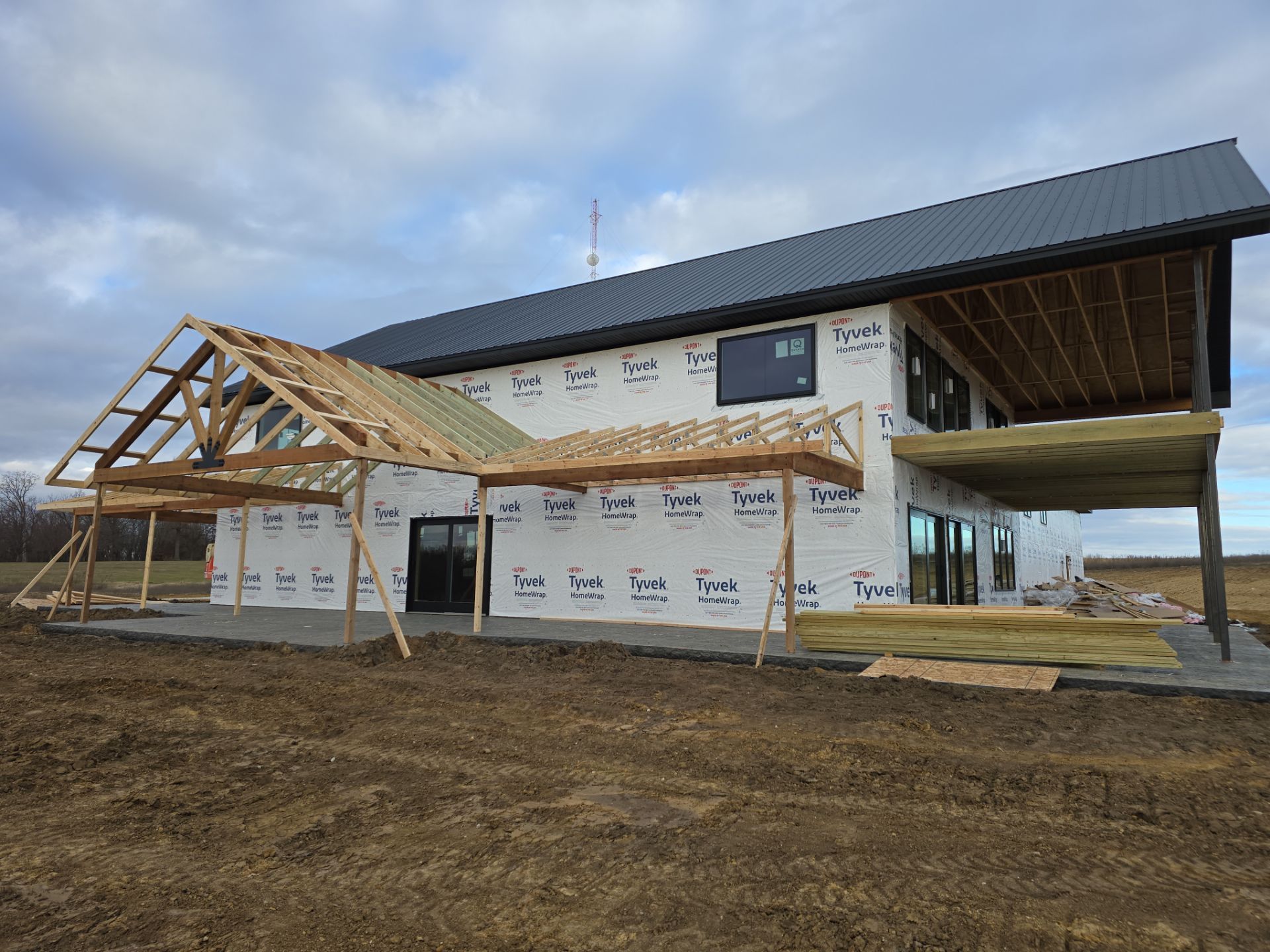 New Home construction w/ board and batten sides and metal roof  by Miles Construction 