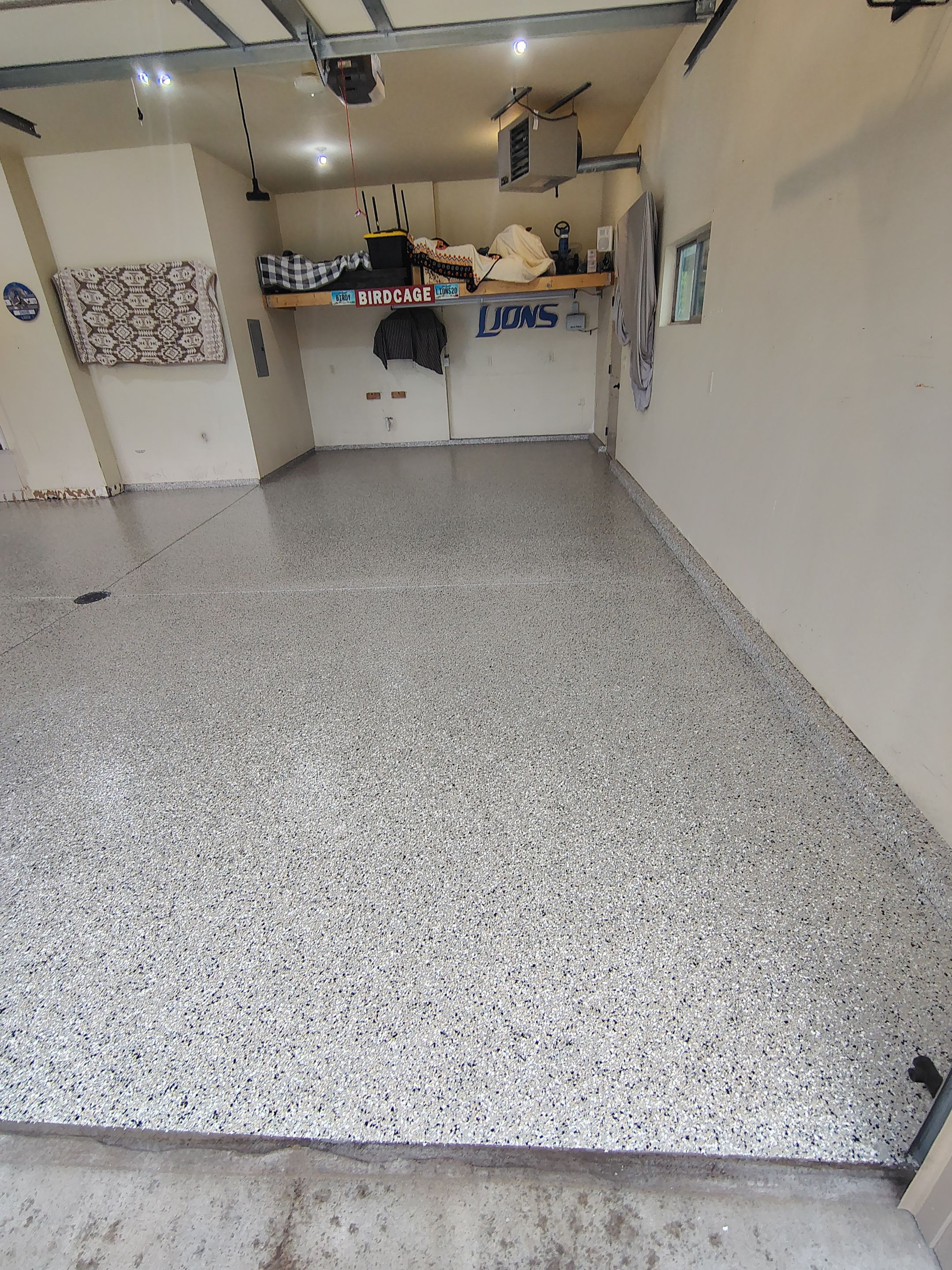 Sioux Falls Garage Floor Repair and Speckled Epoxy Coating Installation by Select Painting, Coatings & Garage Cabinets