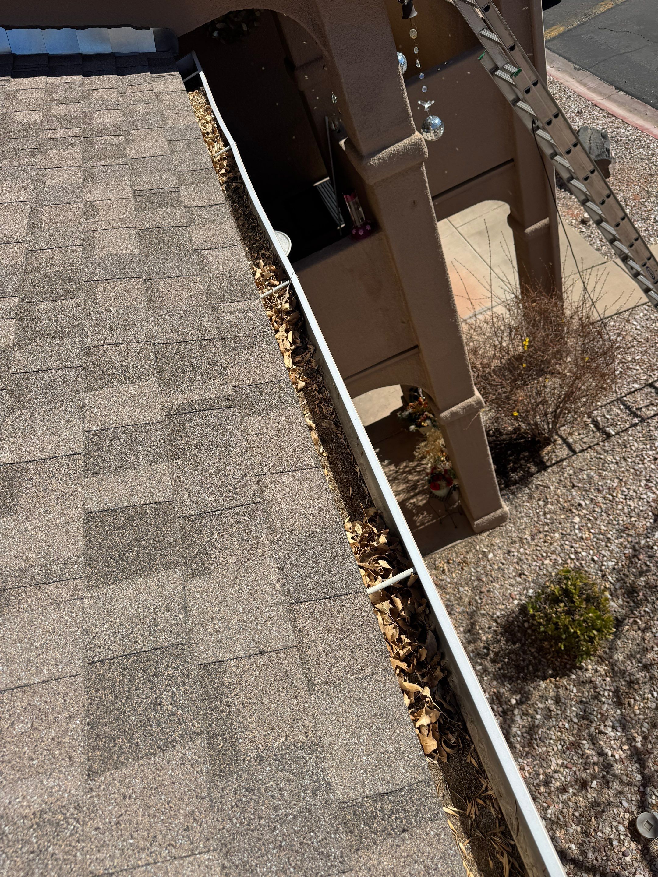 HOA gutter cleaning in Mesquite, NV,before photo showing full gutters.