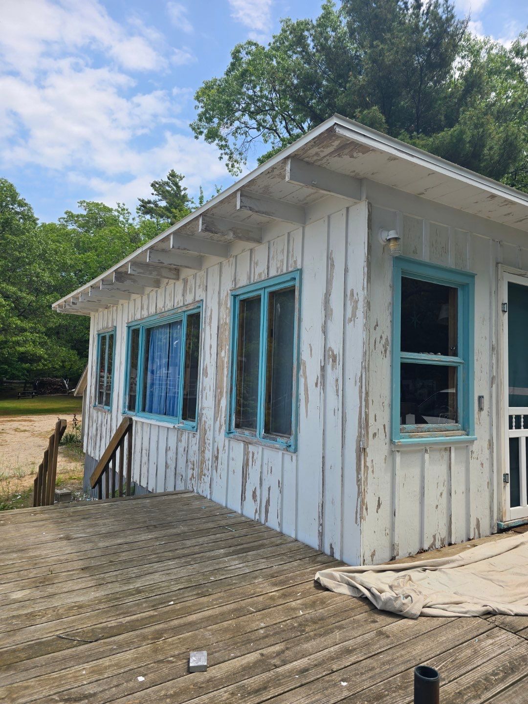 Lakeside Cottage Exterior Painting and Teal Trim Restoration in Mears by Gordon Painting