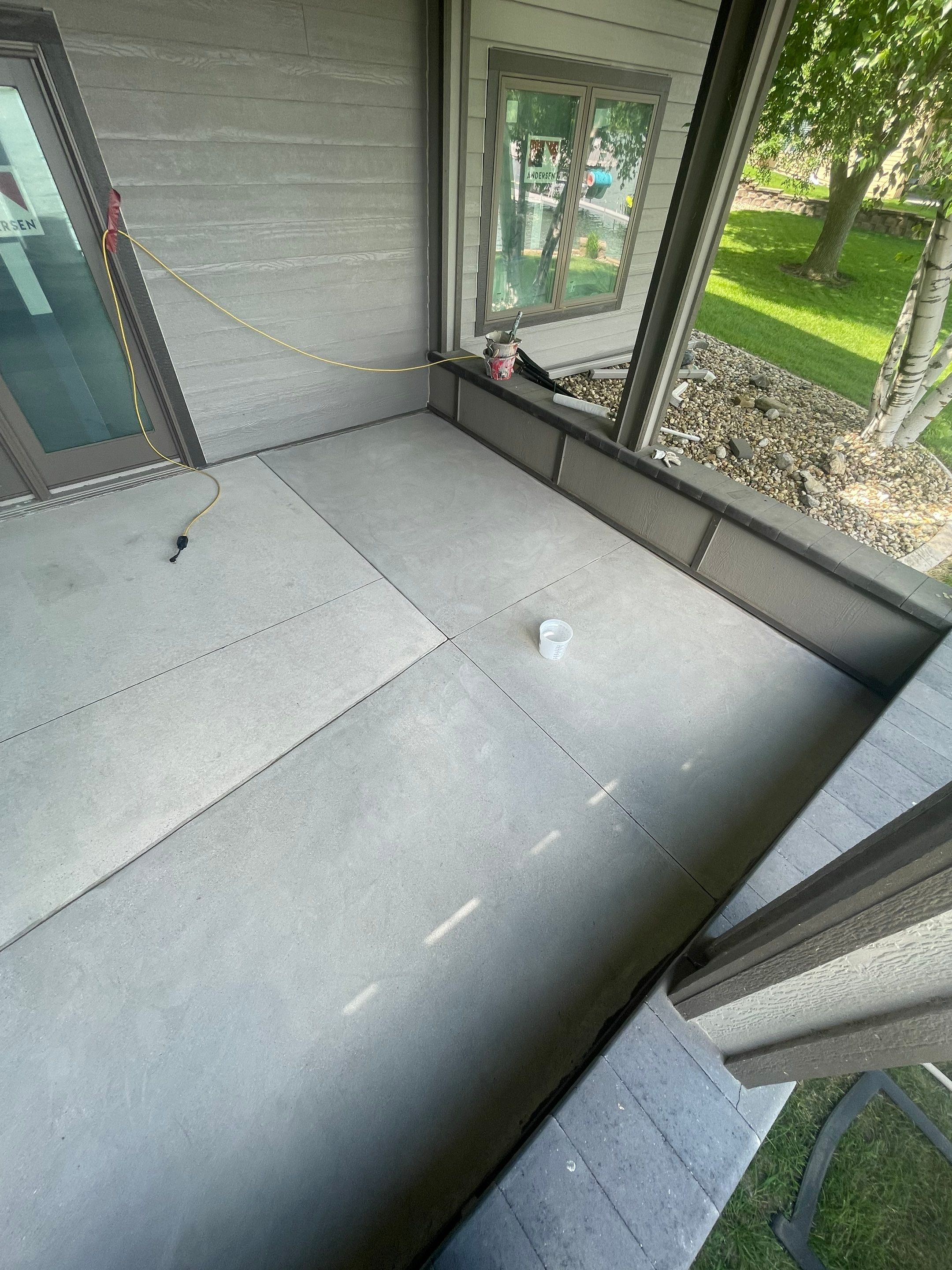 Lakefront Screened Patio Concrete Coating Installation in Wentworth by Select Painting, Coatings & Garage Cabinets