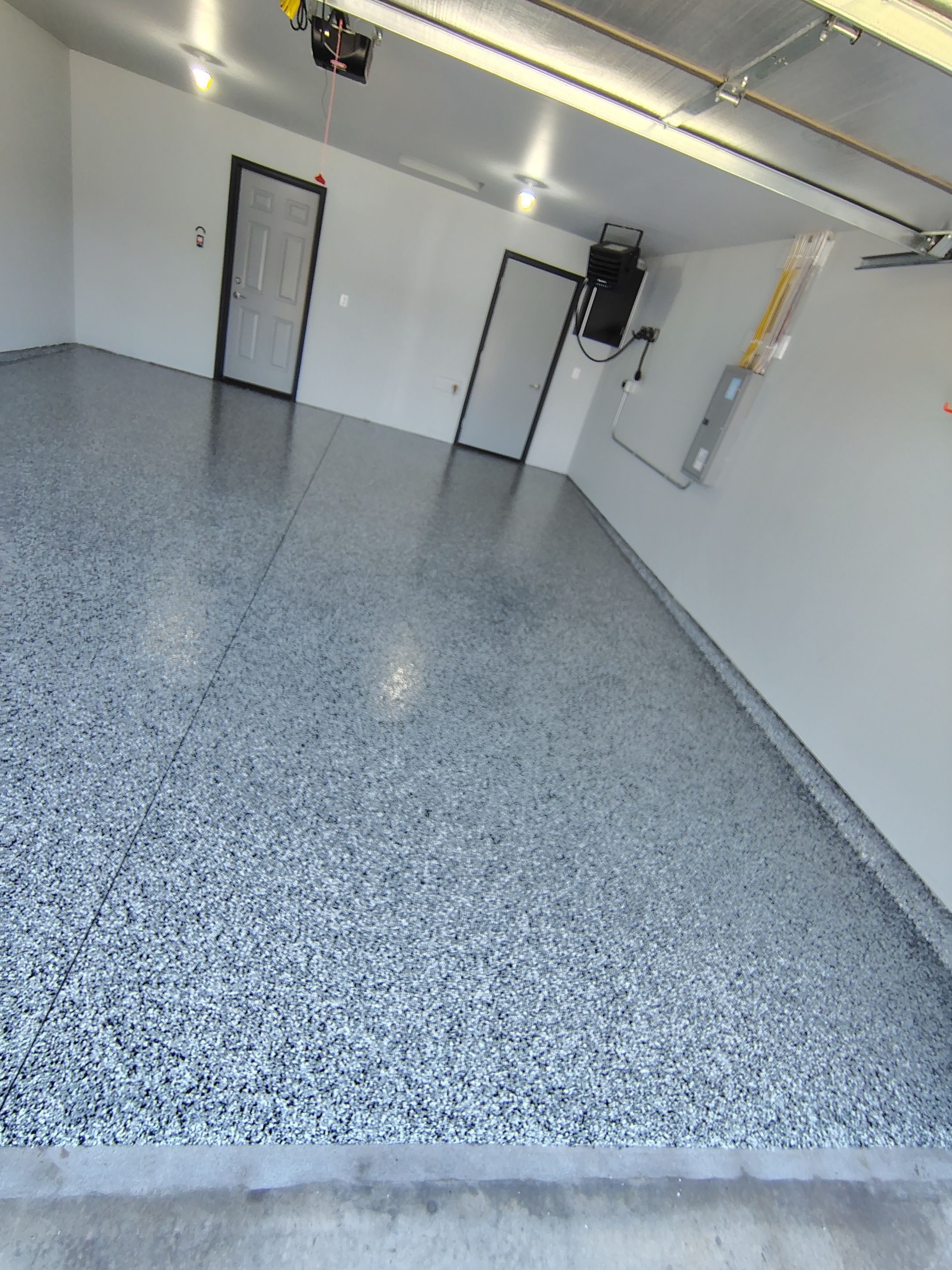 Custom Epoxy Garage Floor Coating Installation in Sioux Falls by Select Painting, Coatings & Garage Cabinets