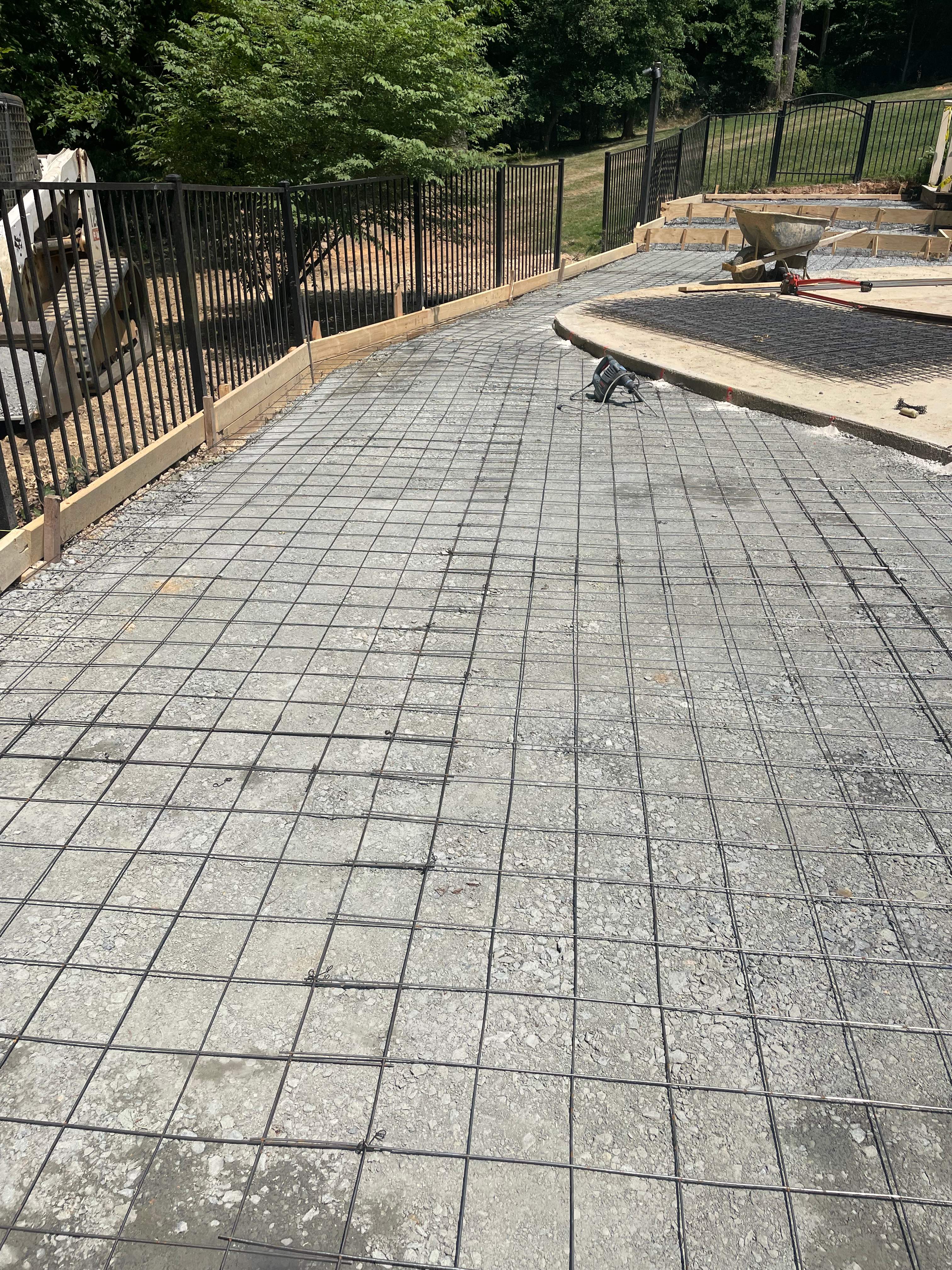 Pool Surround remodel with retaining walls, new waterfall and water slide by Fairfax Contractors, LLC