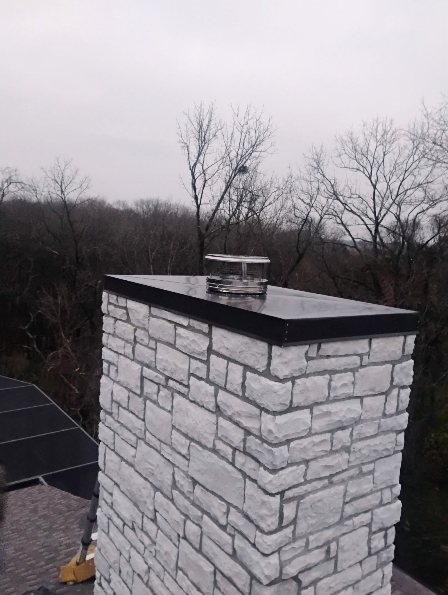 Roof and Gutter System Replacement with Stone Chimney Rebuild by Undersun Roofing 