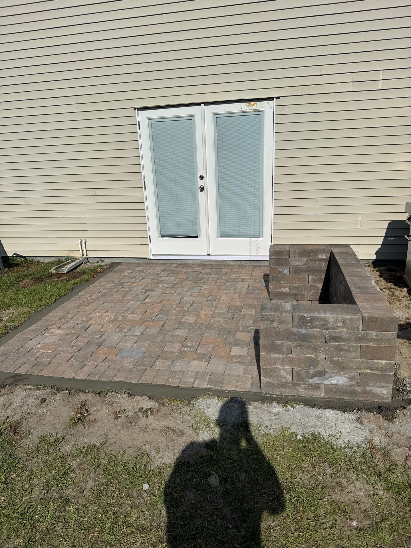 Custom Herringbone Paver Patio and Retaining Wall in Bluffton by Lowcountry Scapes, LLC