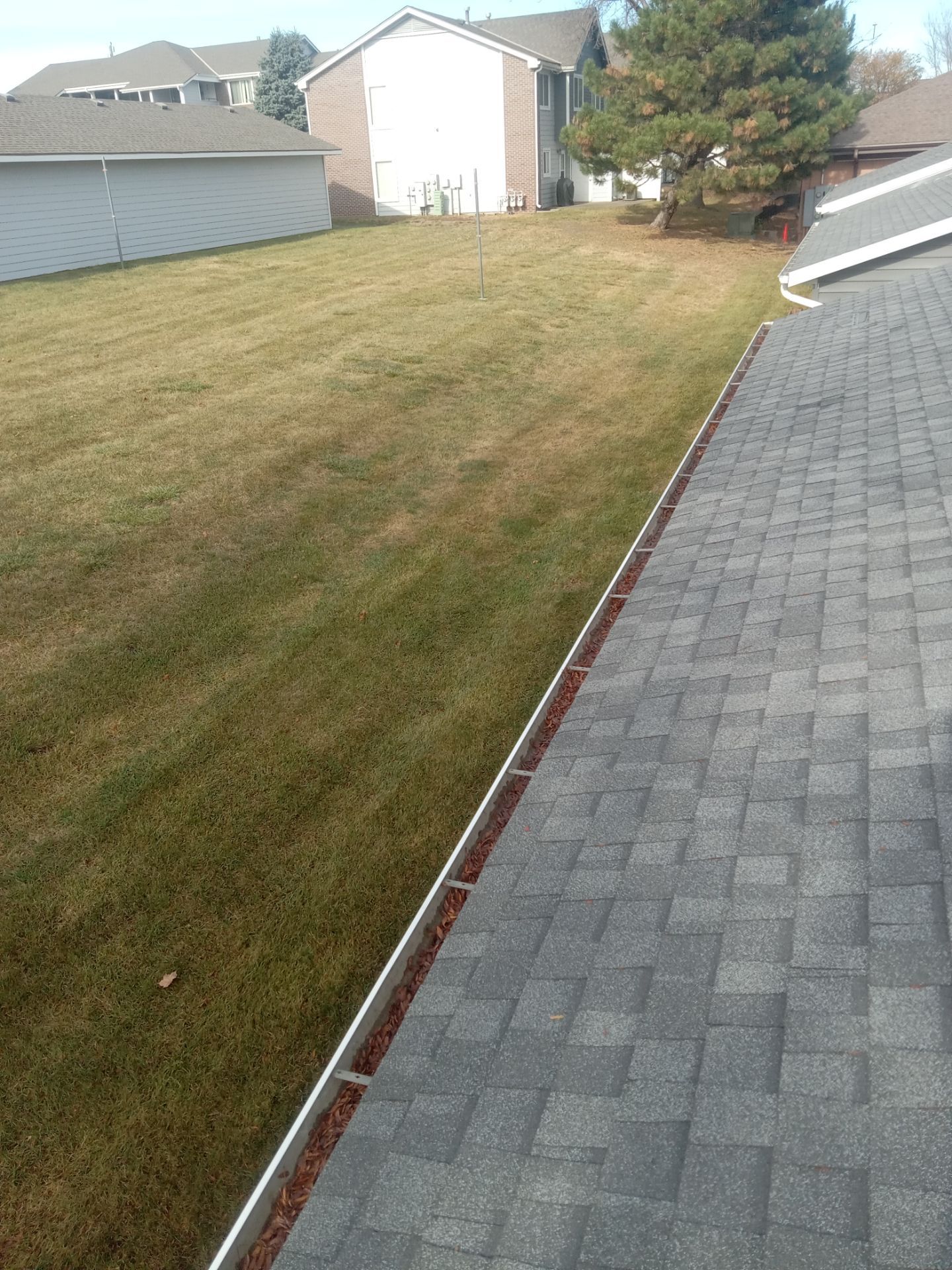 Commercial gutter cleaning South Dakota before photo with filled gutters