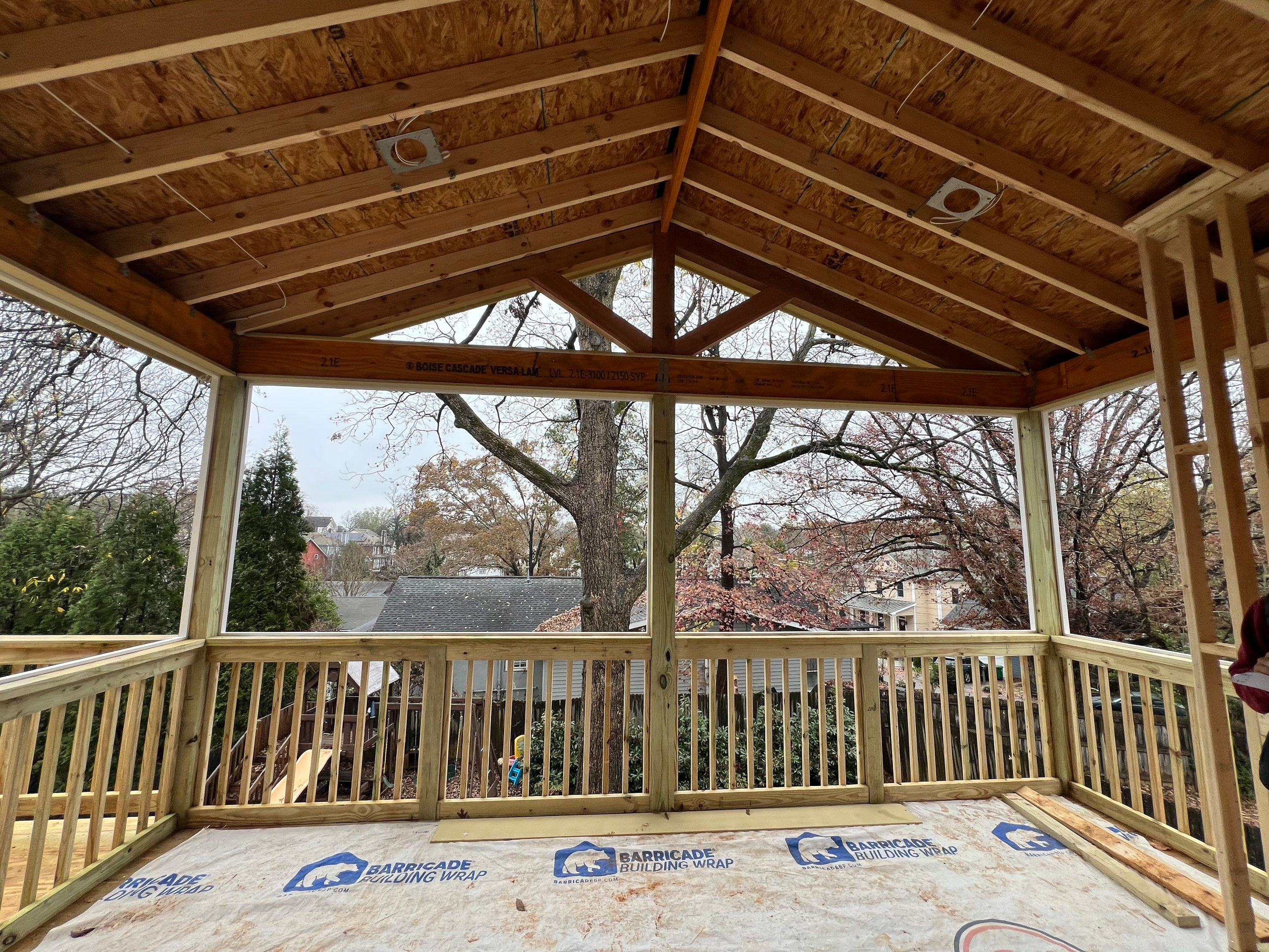 Screened-In Porch With Fireplace by Swift Home Renovations 