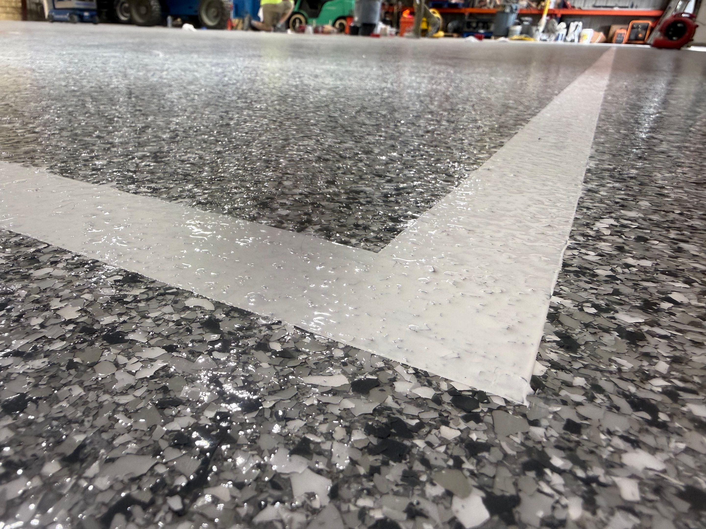 Custom Polyurea Shop Floor with Basketball Court Lines in Rock Valley by Select Painting, Coatings & Garage Cabinets