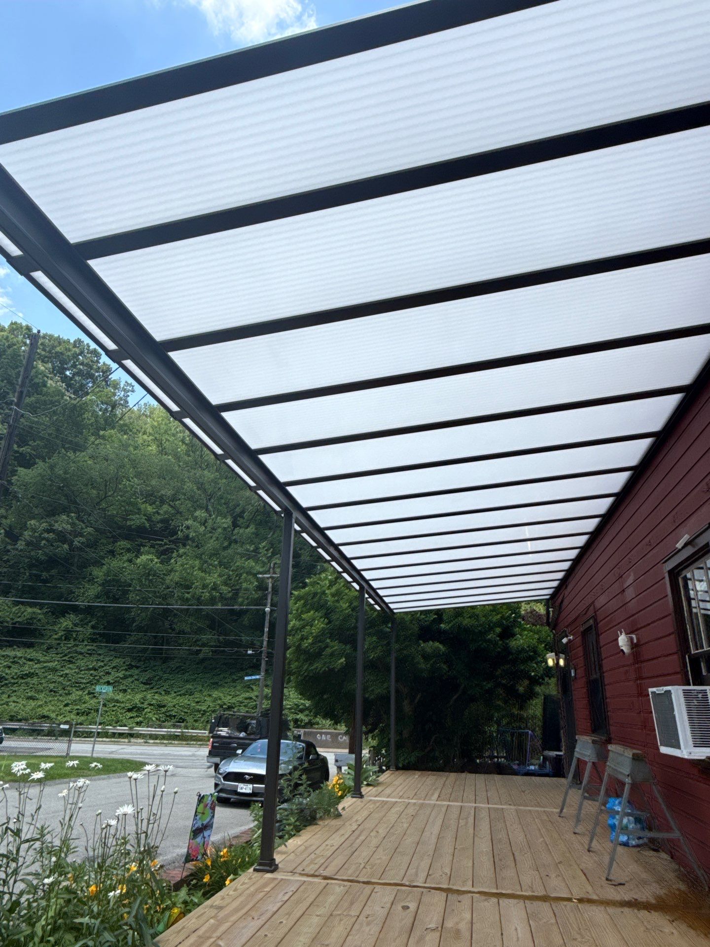 Roof sunspace deck  by Cousins Roofing Siding & Decks