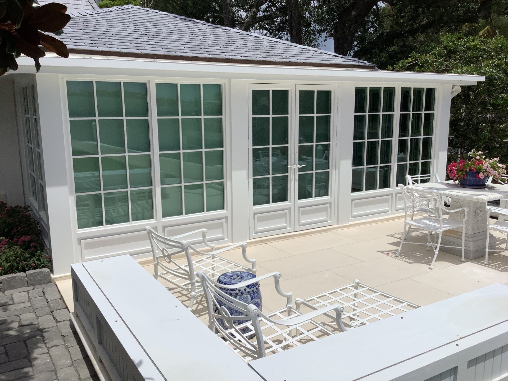 Seamless aluminum gutter installation in Sarasota, FL using 3x4 elbow downspouts combined with round downspouts by Gutter Professors