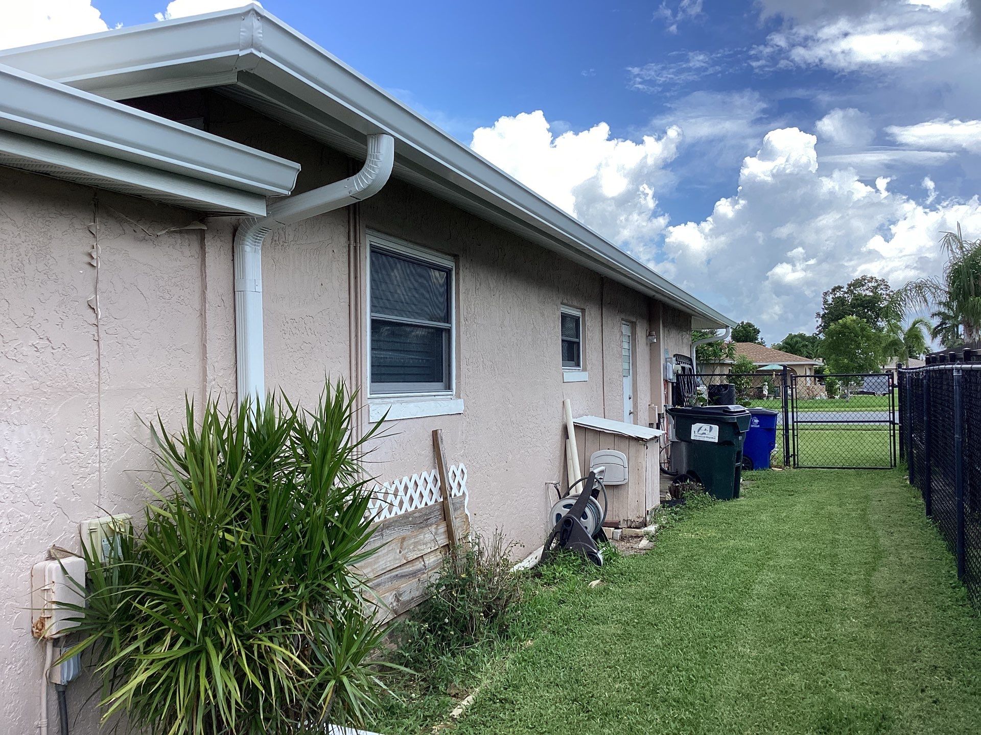White Seamless Gutters and Splash Guards in Fort Myers FL by Gutter Professor by Gutter Professors