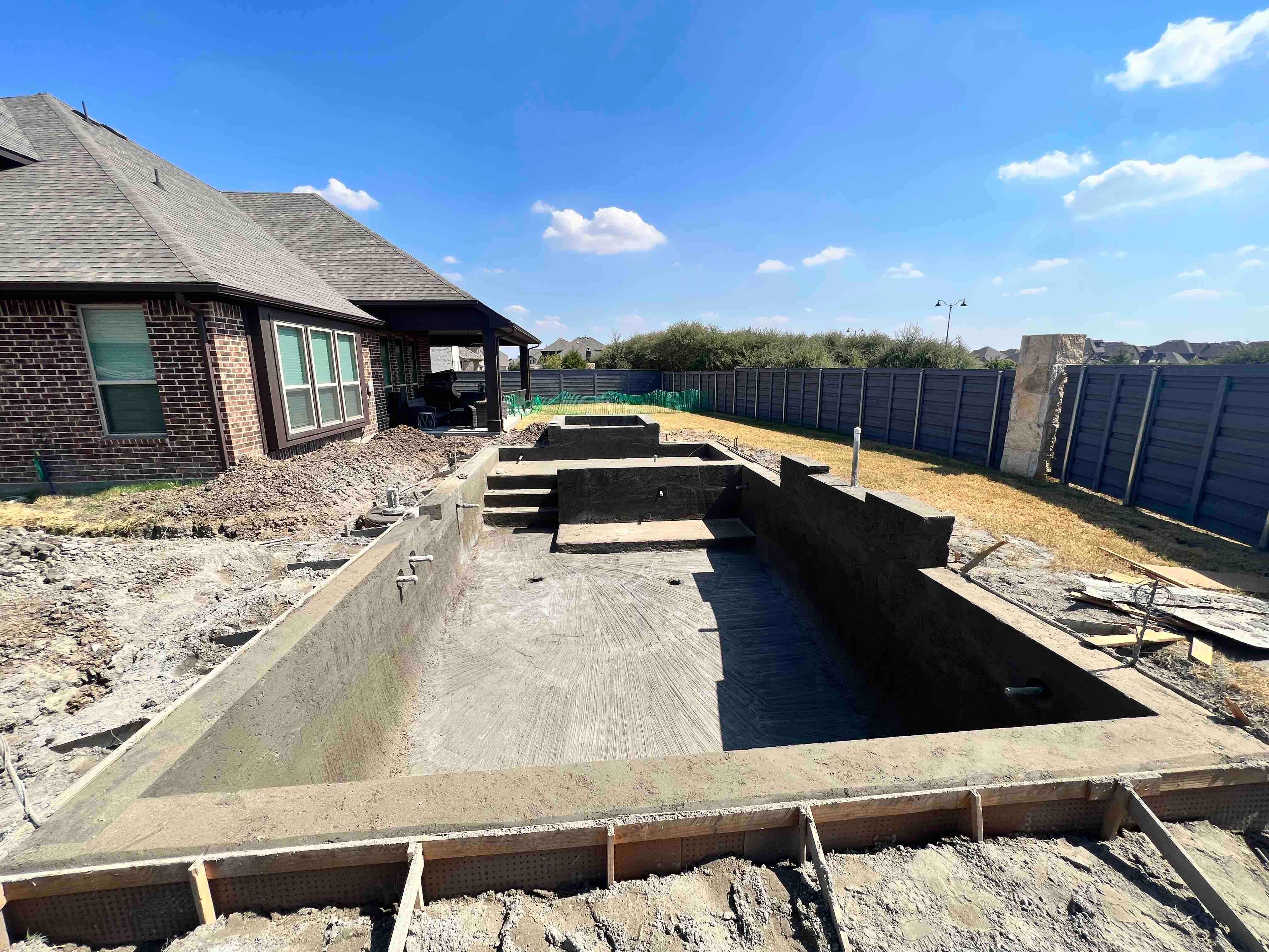 Geometric Pool with Raised Spa and Tanning Ledge by Pinnacle Pools and Spas - DFW