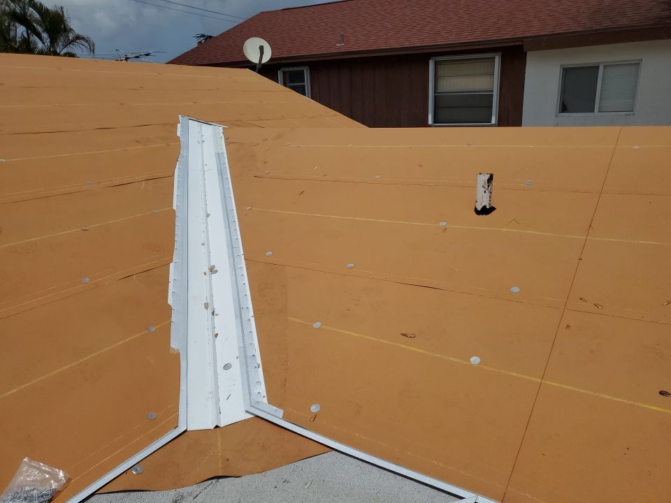 Residential Roofing Installation using 1.5" Nail Strip 24ga Solar White Kynar Coated Standing Seam Metal Panels by Morton Roofing, Inc.