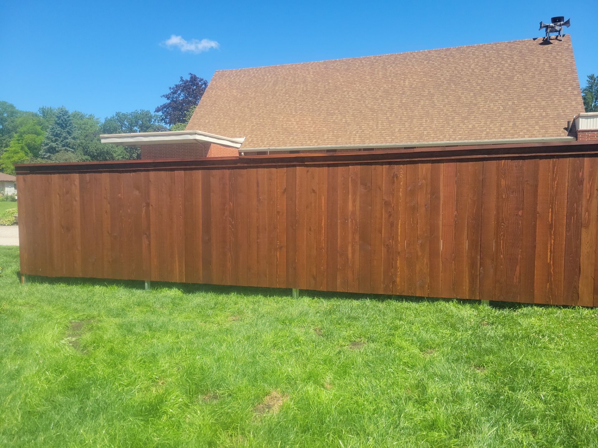 Custom Stained Cedar Chestnut Privacy Fence Installation in Cedar Falls by Perfect Picket Fence and Stain