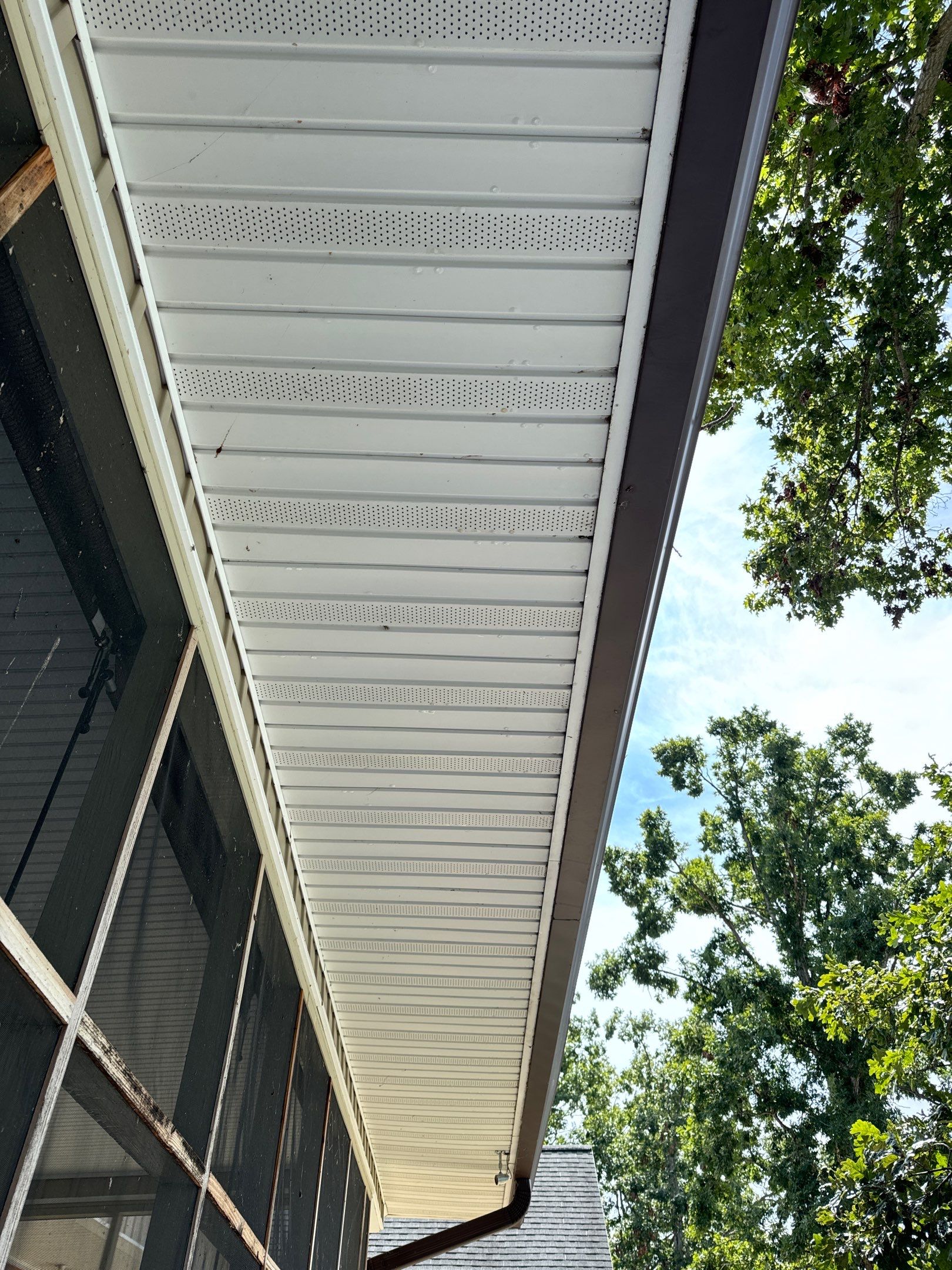 cleaning the exterior soffit and overhang to remove dirt and debris for a refreshed appearance and improved maintenance