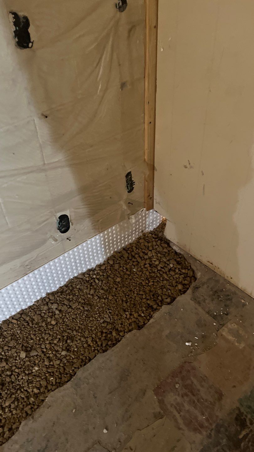 Interior drain tile system installation by ACE Waterproofing & Basement Solutions